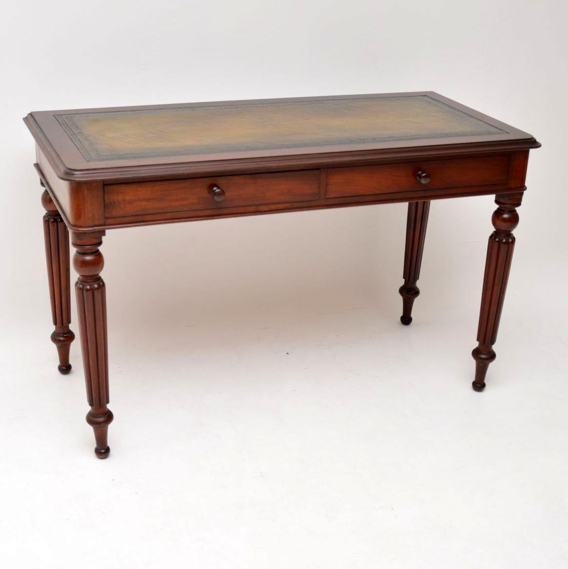 This antique Victorian mahogany writing table is of high quality & is quite large with a decent size working area. The leather writing surface has lots of character & is hand tooled. The are two drawers below, with turned bun handles & Fine