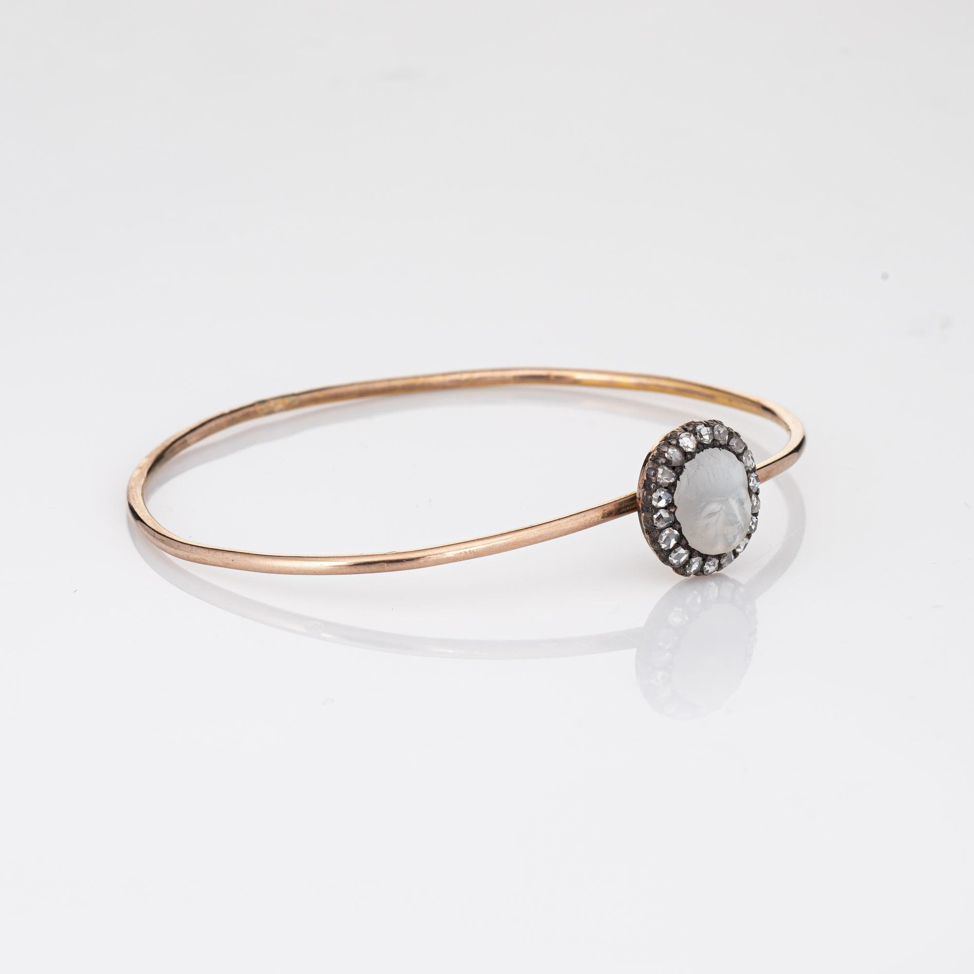 Distinct antique Victorian moonstone & diamond bangle bracelet (circa 1880s to 1900s) crafted in 9k yellow gold. 

Carved moonstone measures 8.5mm x 7mm, accented with 18 estimated 0.03 carat old rose cut diamonds. The total diamond weight is