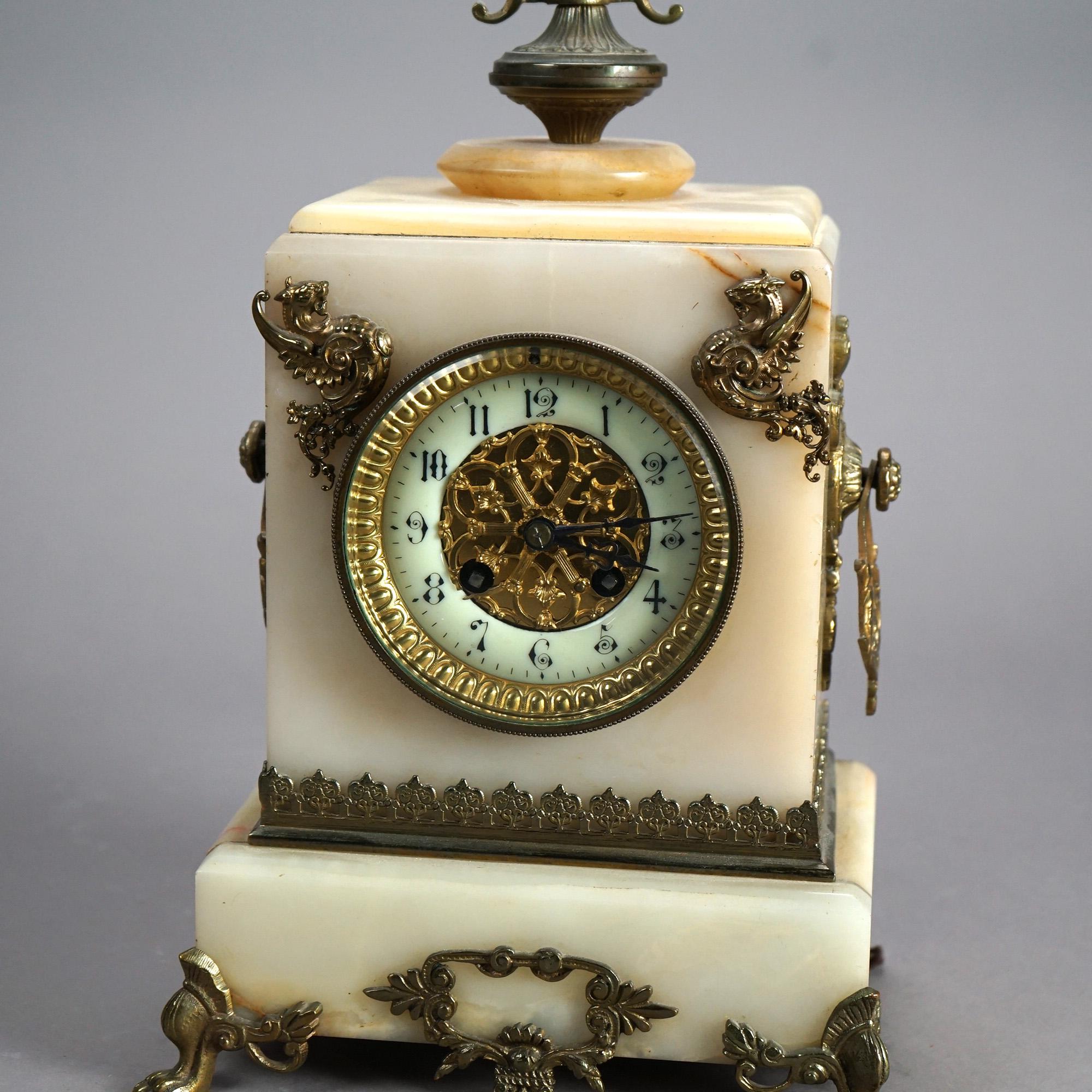 An antique Victorian carriage clock offers marble case with cast bronze mounts including Amphiptere dragons and foliate elements, c1880

Measures- 15''H x 8.75''W x 5.75''D