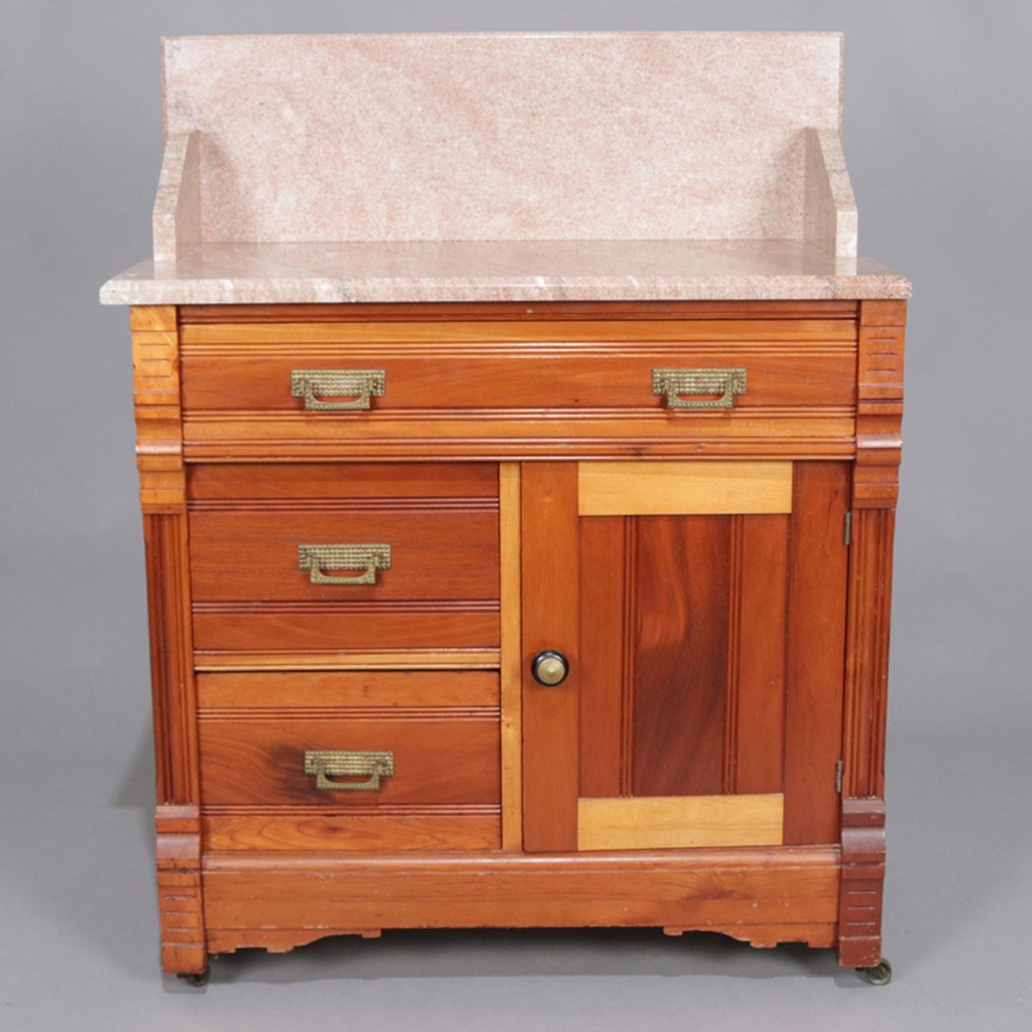 Antique Victorian wash stand features marble top with backsplash above two-toned walnut case having upper frieze drawer and two lower drawers and cabinet, circa 1890


Measures: 38.5