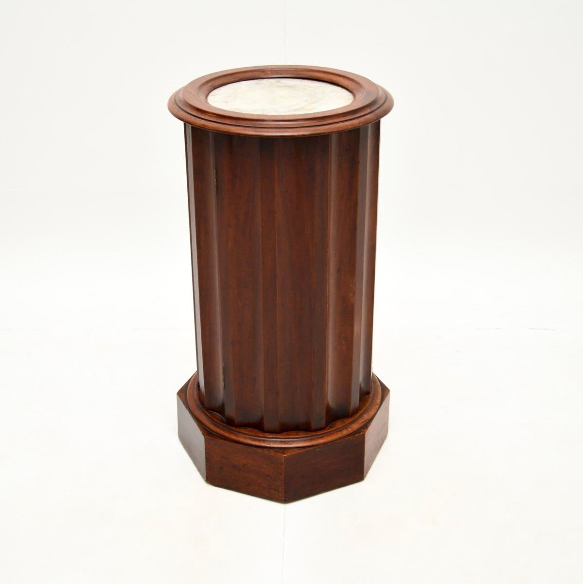A wonderful antique Victorian marble top cylinder pedestal cabinet. This was made in England, it dates from around the 1840-1850 period.

It is of great quality, with a smart and useful design. The cylindrical shaped body sits on a plinth base with