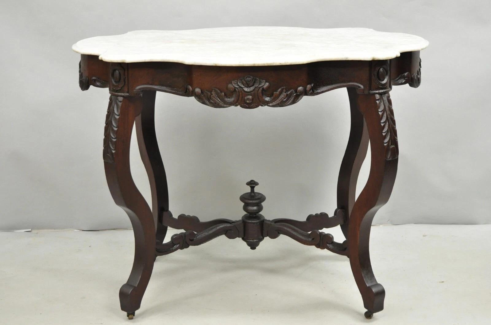 Please message us with your zip code to request a more reasonable domestic U.S. shipping quote.

Antique Victorian Marble Turtle Top Mahogany Wood Parlor Center Table with Alligatoring Shellac Finish and Carved Finial Stretcher Base. Circa Late 19th