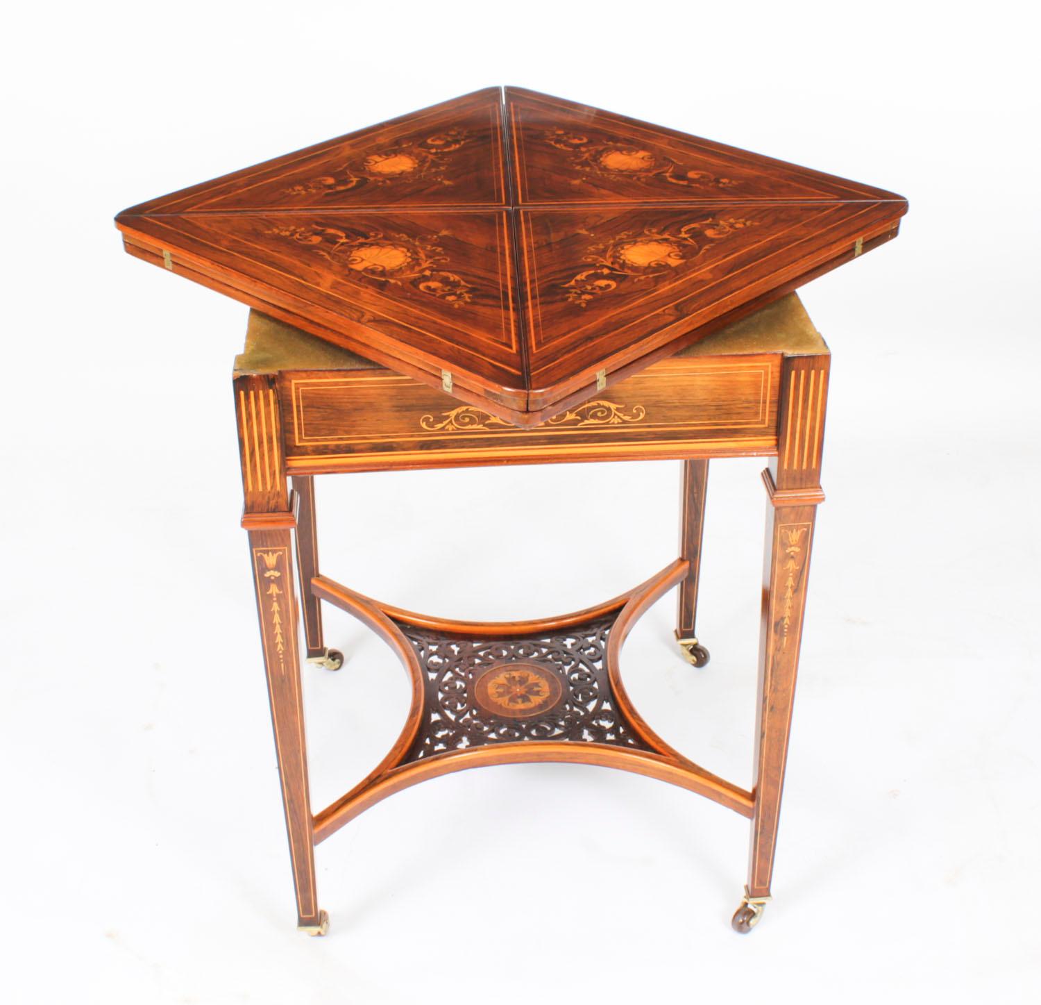 This is a beautiful antique Victorian envelope card table, circa 1880 in date.
 
The card table is made from superb quality Gonçalo Alves and has striking floral and foliate marquetry decoration.
 
The swivelling top opens like an envelope,
