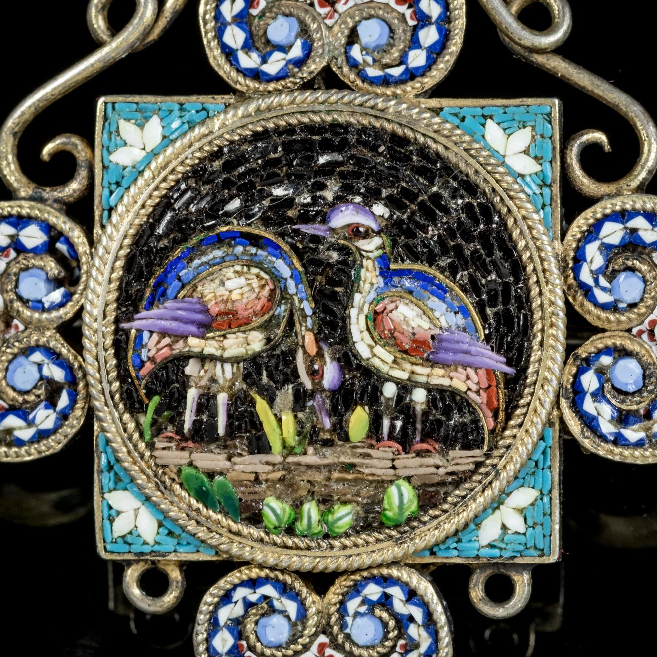 This beautiful antique Micro Mosaic bird pendant/ brooch is Victorian, Circa 1860.

The delightful piece features a central Mosaic made up of micro pieces creating a vibrant image of tall exotic birds feeding in the foliage. 

Victorian jewellery