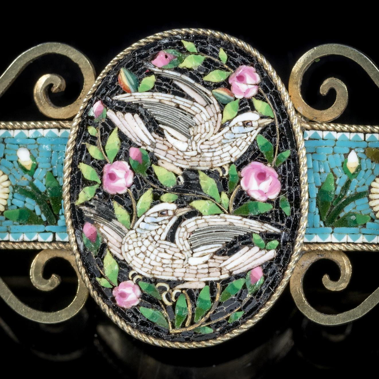 This pretty antique Micro Mosaic Dove brooch is Victorian, Circa 1860. 

The wonderful brooch features a beautiful Micro Mosaic image in the centre depicting two white Doves surrounded by pink Roses.

A Dove has long been a symbolic image of peace