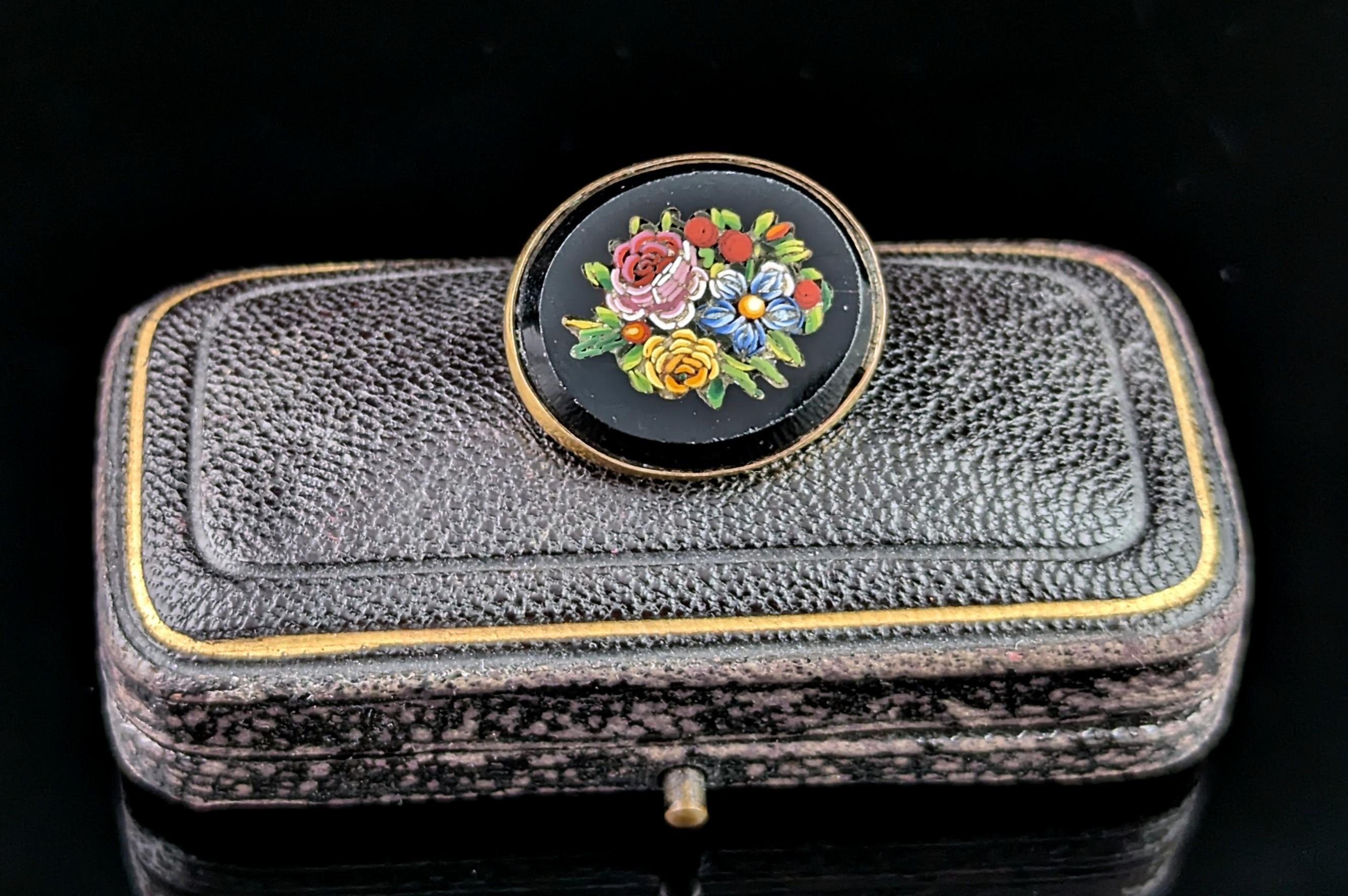 An attractive and well detailed little antique micro mosaic brooch. 

A 19th century Grand Tour piece it depicts a nicely done image of a floral display the tesserae set into a rich inky black glass which resembles black onyx. 

The floral display