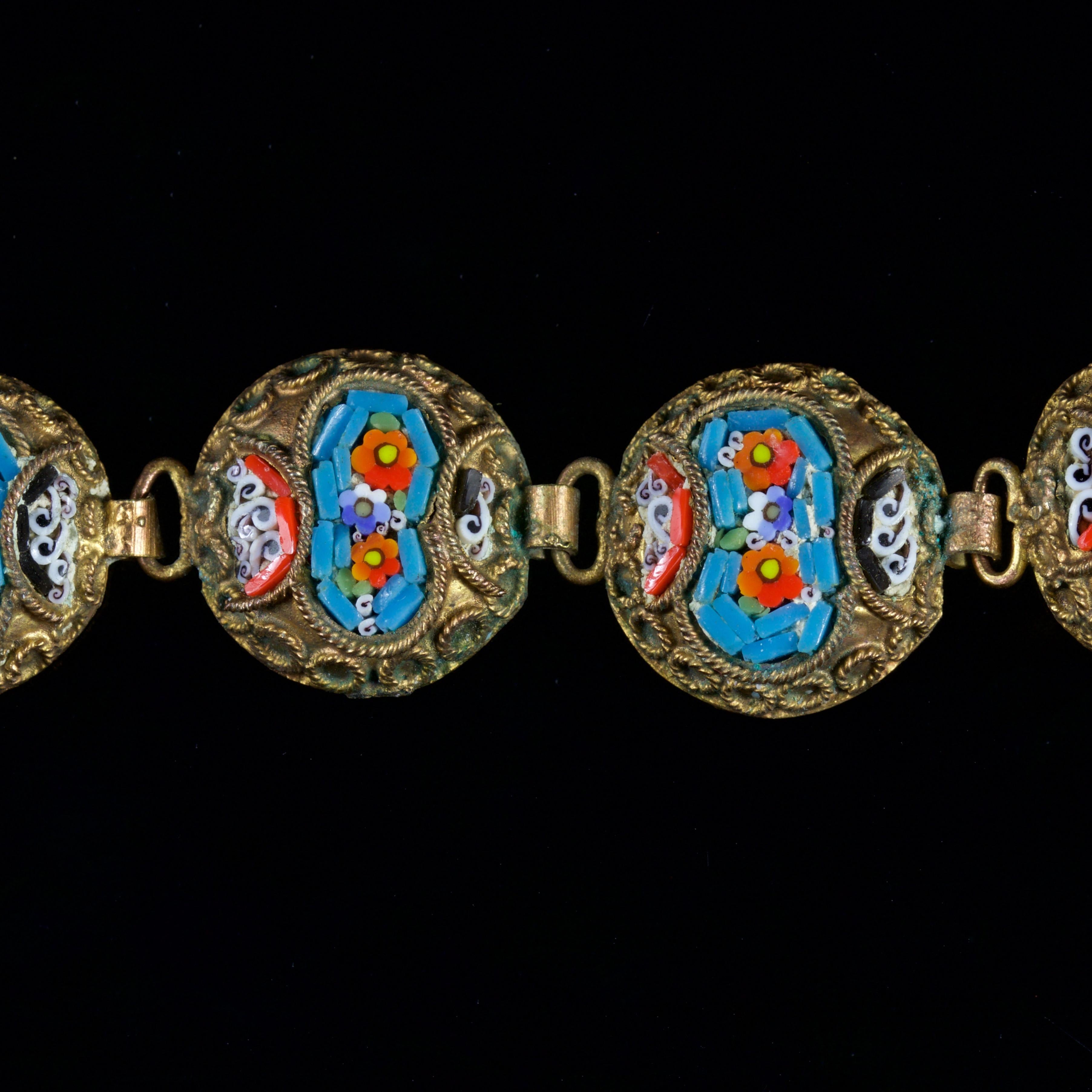 This Victorian Micromosaic bracelet is simply wonderful, Circa 1880.

The bracelet boasts 10 sections showing mosaics of orange and blue flowers with a sky blue background.

At either side of the mosaics, there are two more floral patterns in