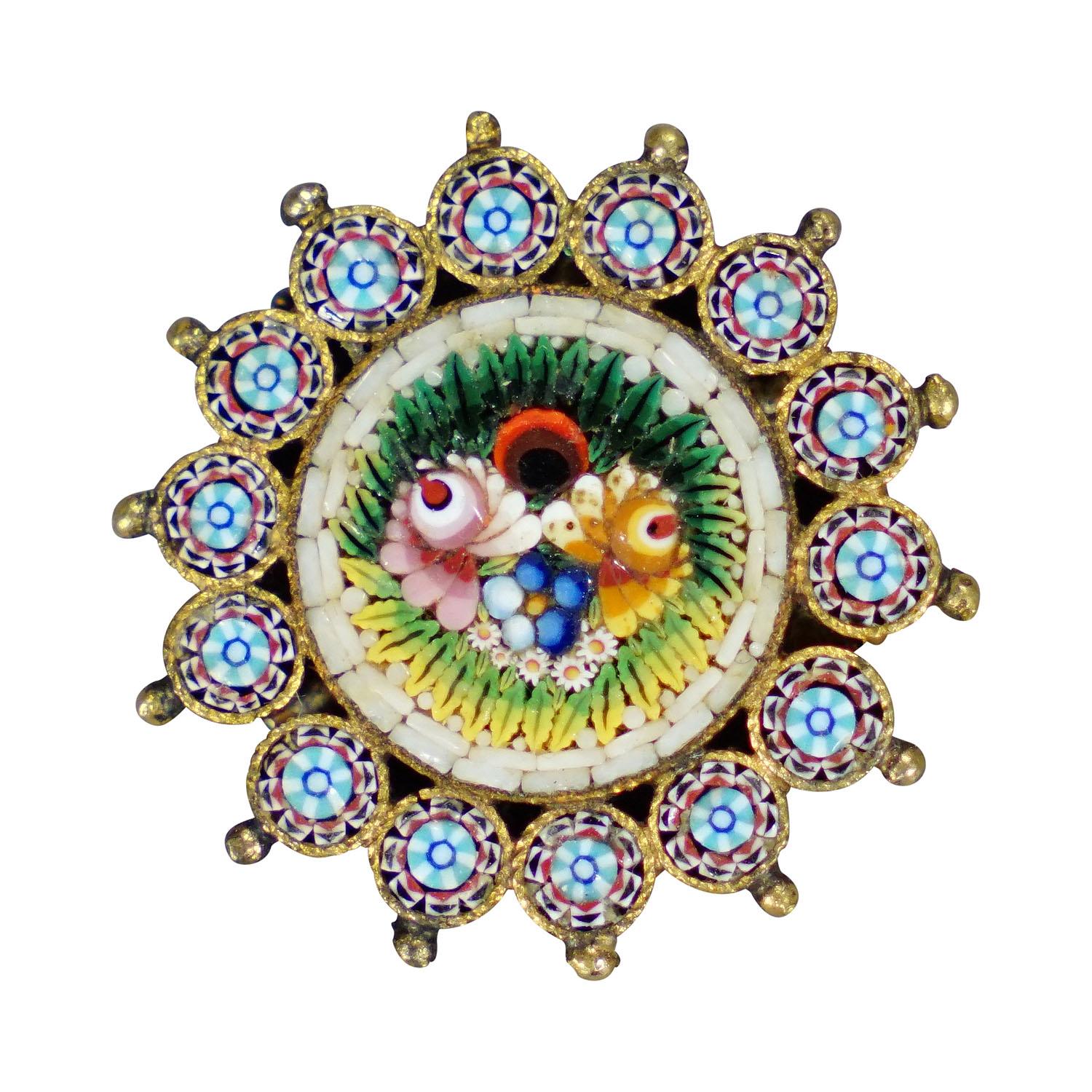 Antique Victorian Micromosaic gilded brooch, Italy early 20th century

A Victorian micromosaic brooch with a central floral bouquet motif surrounded by a ring of small concentric mosaics and gilded beading. Manufacturted in Venice, Italy early 20th