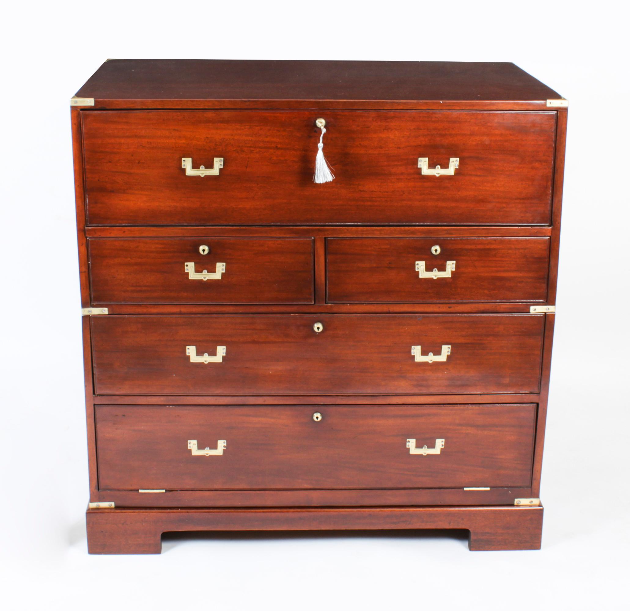 This is beautifully crafted antique early Victorian teak military secretaire chest of drawers, circa 1840 in date.
 
The top drawer opening to a pull out secretary desk with small drawers and compartments, over two short drawers over three long