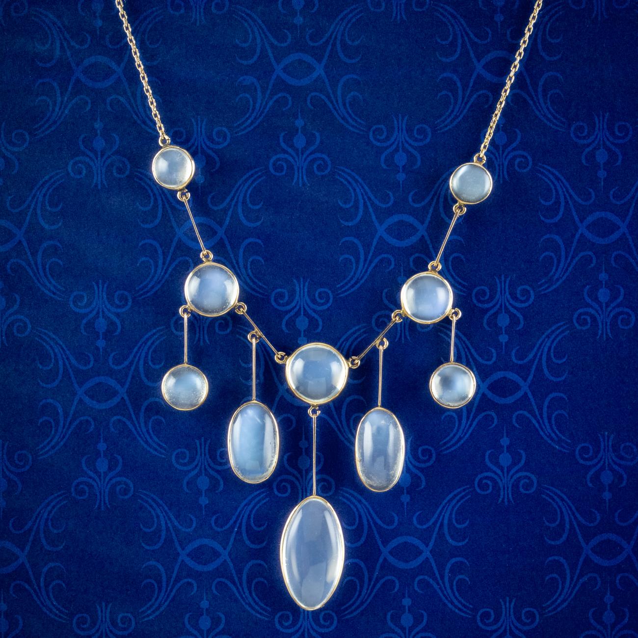 An enchanting antique Victorian necklace adorned with ten mesmerising cabochon moonstones with a ghostly blue schiller. They range from 1 to 8ct and are bezel set along five graduating droppers at the bottom.

The mystifying moonstone derives its