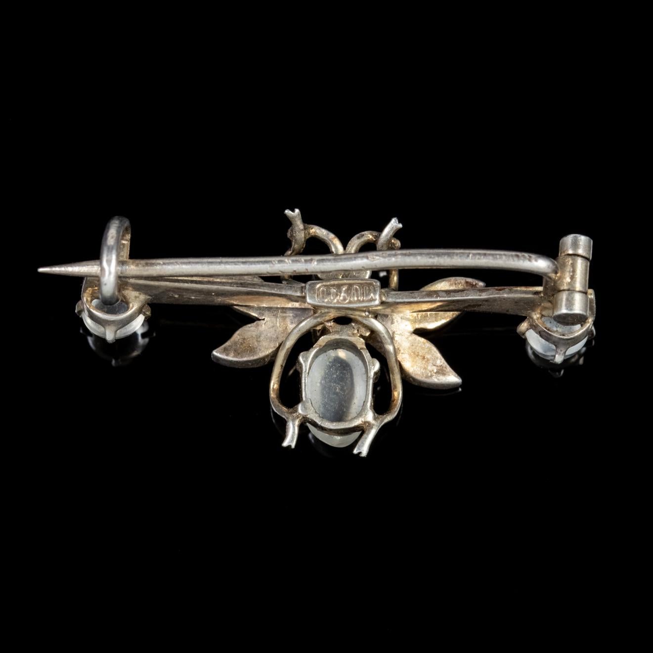 A delightful little antique Victorian brooch featuring a winged insect in the centre made up of lovely Moonstones with Pearl studded wings and red Paste eyes. 

The Moonstones have a lovely ghostly hue and a luminous surface similar to that of