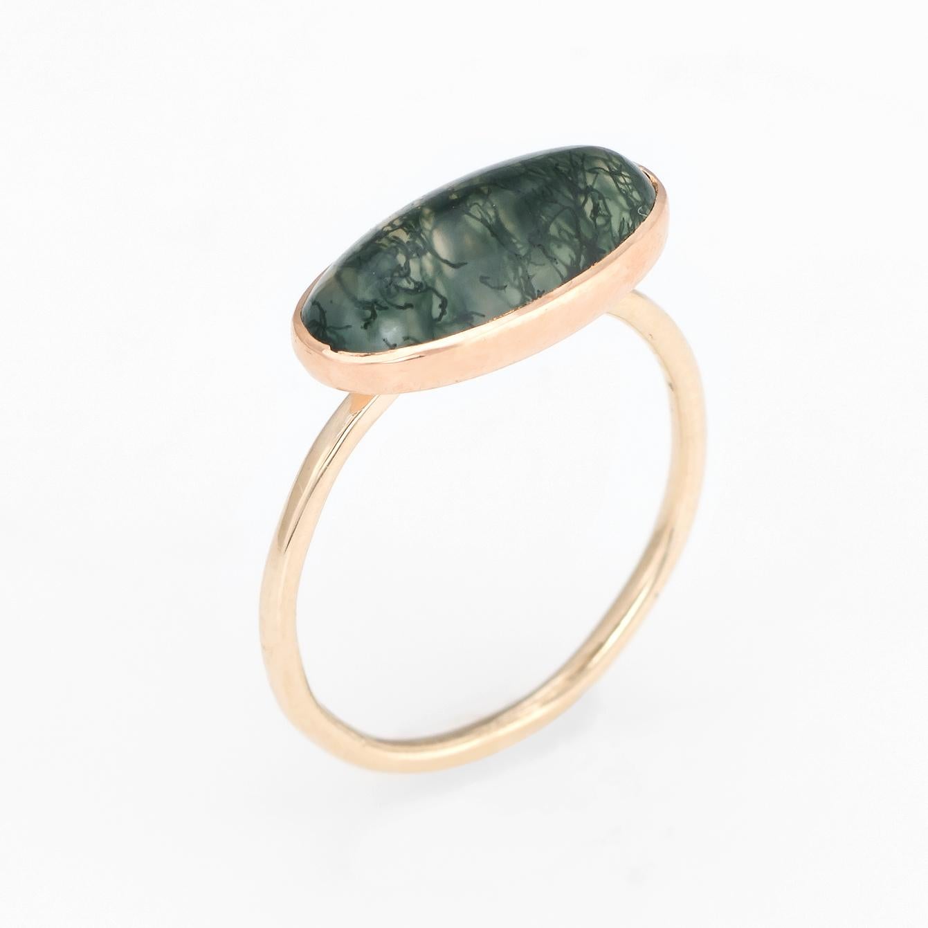 Originally an antique Victorian era stick pin (circa 1880s to 1900s), the moss agate ring is crafted in 14 karat yellow gold.

The ring is mounted with the original stick pin. Our jeweler rounded the stick pin into a slim band for the finger. The