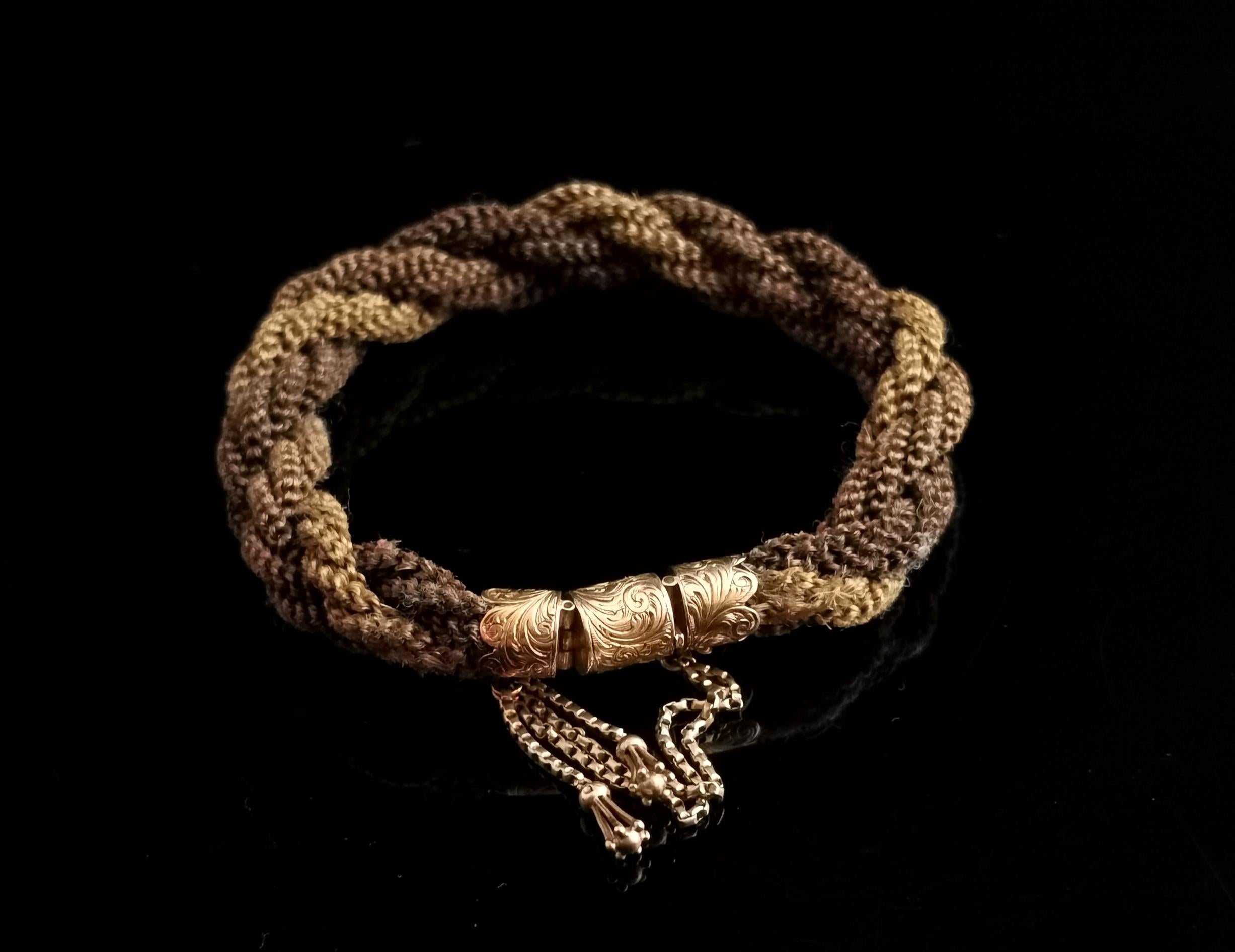 A beautiful antique Victorian era mourning bracelet.

The bracelet is made from tightly woven and intertwined stands of hollow hairwork, there are two shades a medium and light brown, this tells us that the bracelet was probably crafted from the