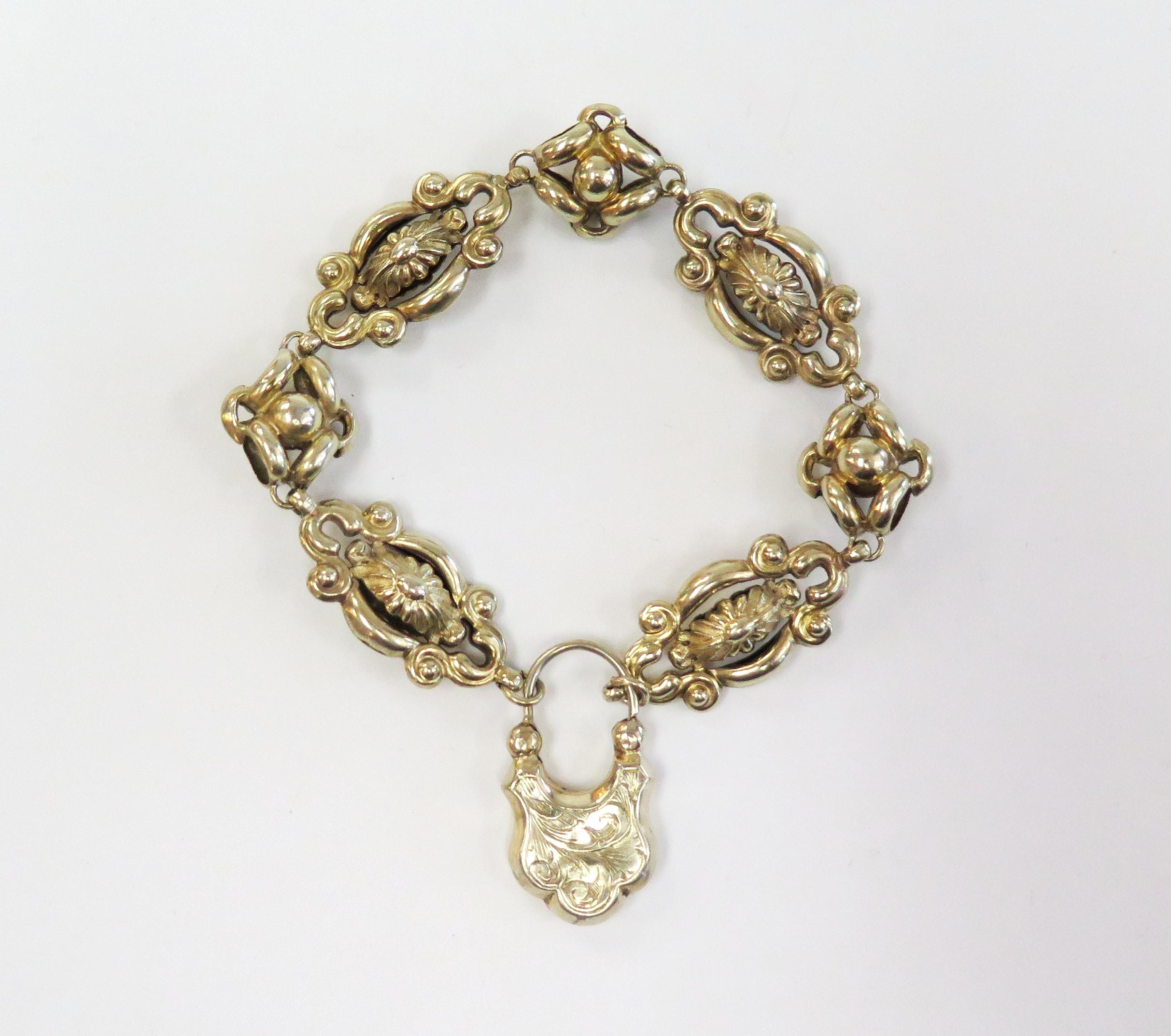 Very unusual Victorian Mourning Bracelet has puffed ornate links and a padlock clasp. One side of the clasp has a black 