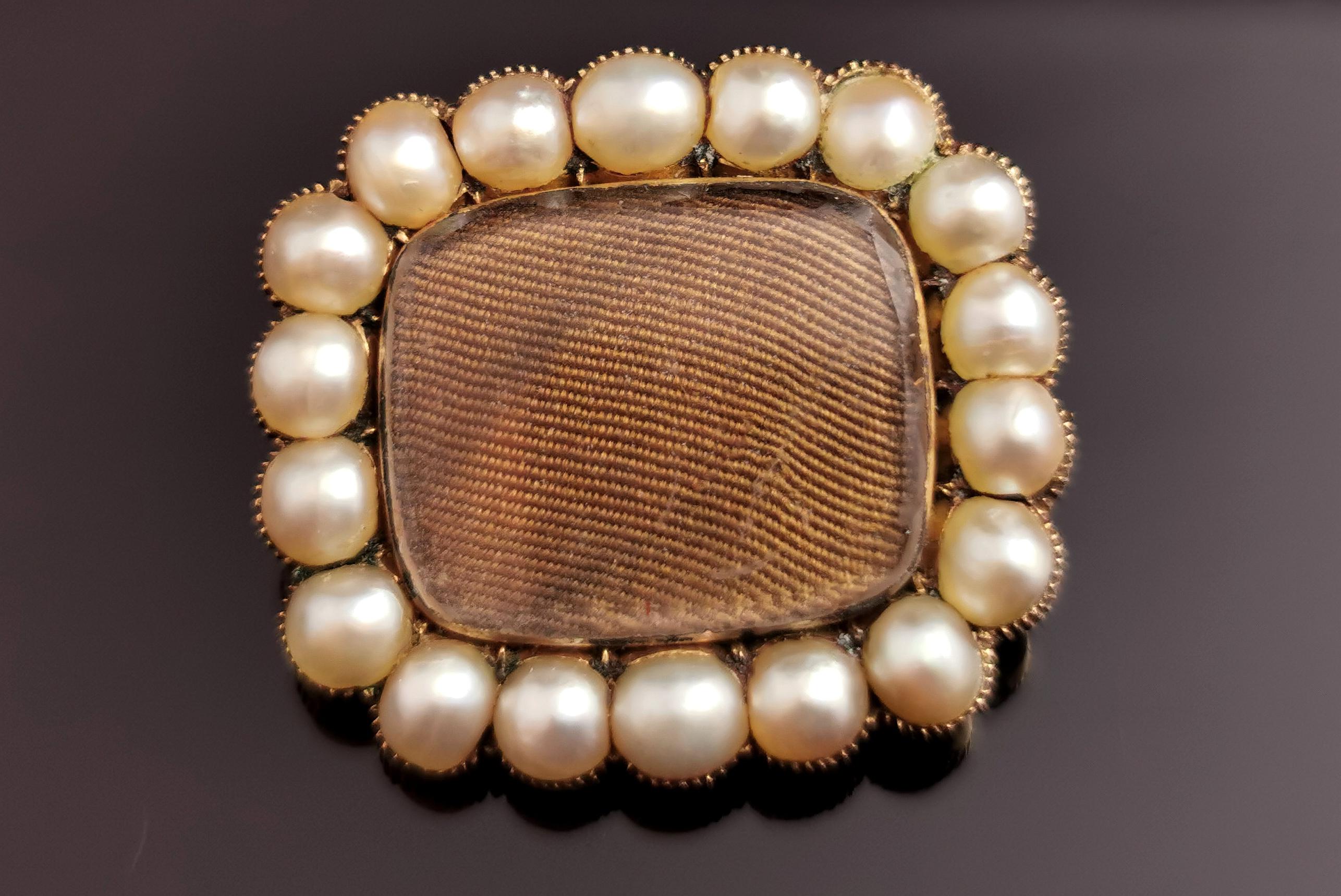 A beautiful antique Victorian mourning brooch.

Early to mid Victorian this brooch is a rounded rectangular shape with a glazed front compartment enclosing very tightly woven light brown hair.

It has a border of creamy split pearls and is set in