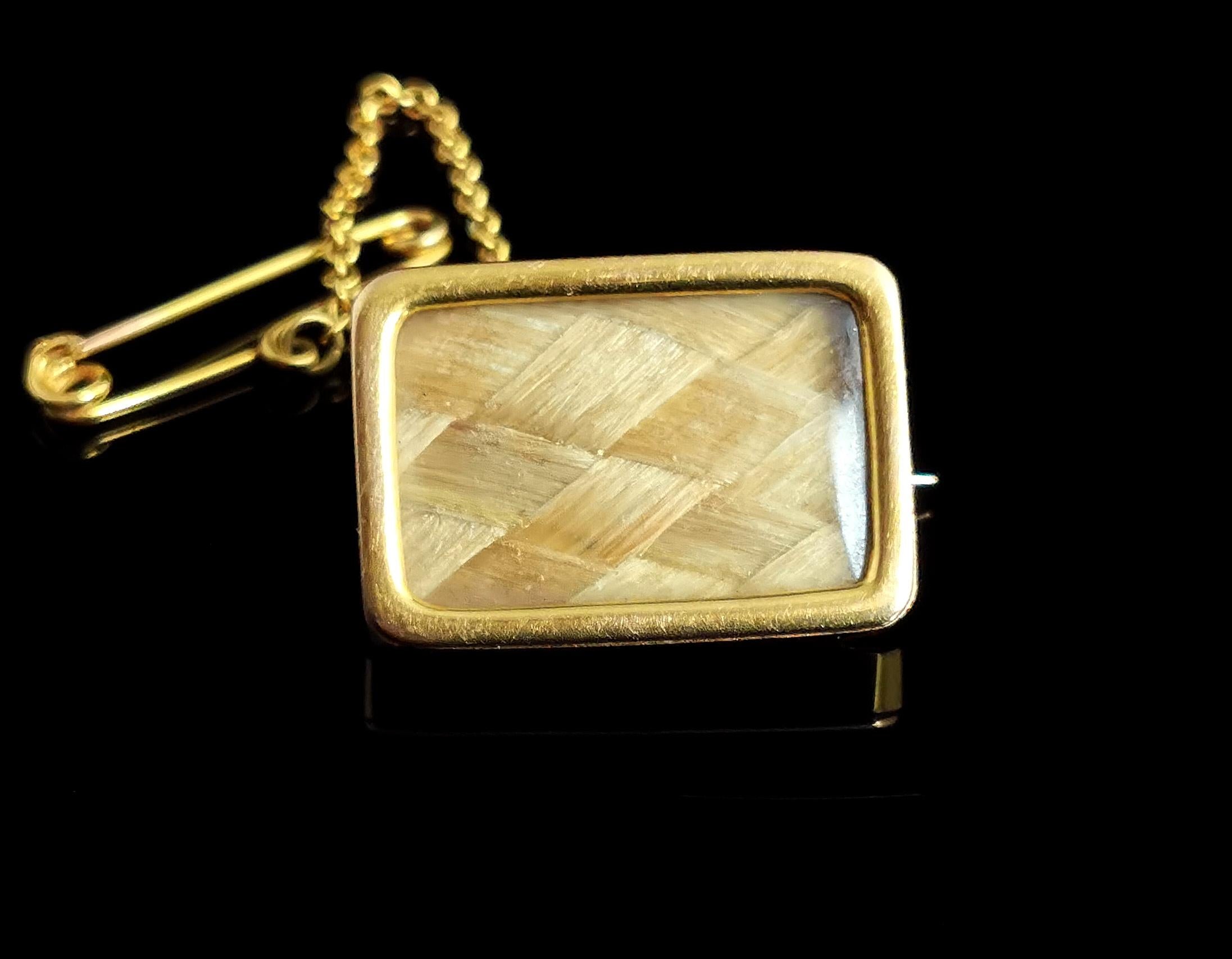 A sweet and unusual antique Victorian 9kt gold mourning brooch or pin.

A small sized brooch with a rectangular 9kt yellow gold frame and back, the front with a glazed panel, enclosing a finely plaited lock of golden blonde hair.

It has simple