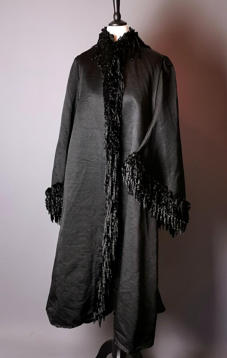An absolutely excuisite Victorian mourning coat with dolman sleeves, adorned with velvet and real jet beads.

This decadent and rich inky black mourning piece is a museum worthy piece, so expertly put together from the finest of materials.

It is