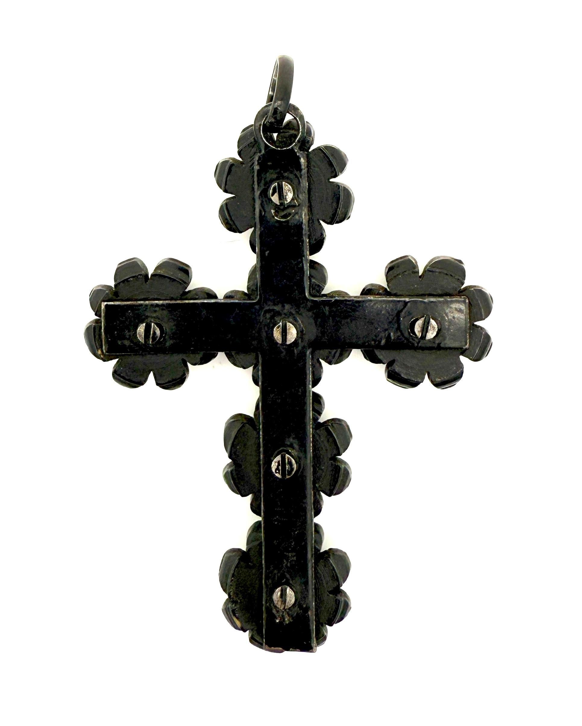 This Victorian cross was created in the 1880's. It is made out of six identical flowers. Each flower is made out of pressed wood. All flowers are executed in relief. Each flower is composed of eight larger and eight smaller flower petals, each with