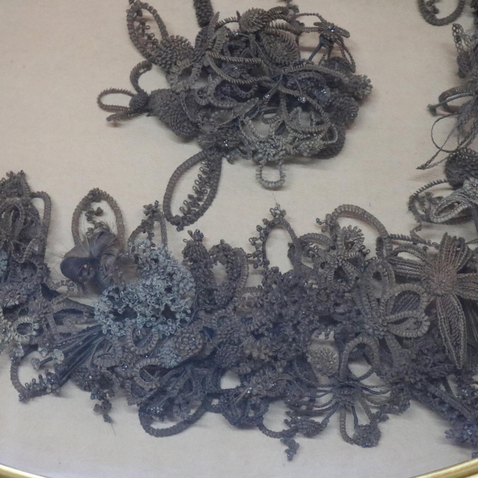 An antique Victorian mourning hair wreath mounted in deep giltwood shadowbox frame, circa 1880

Measures: 24