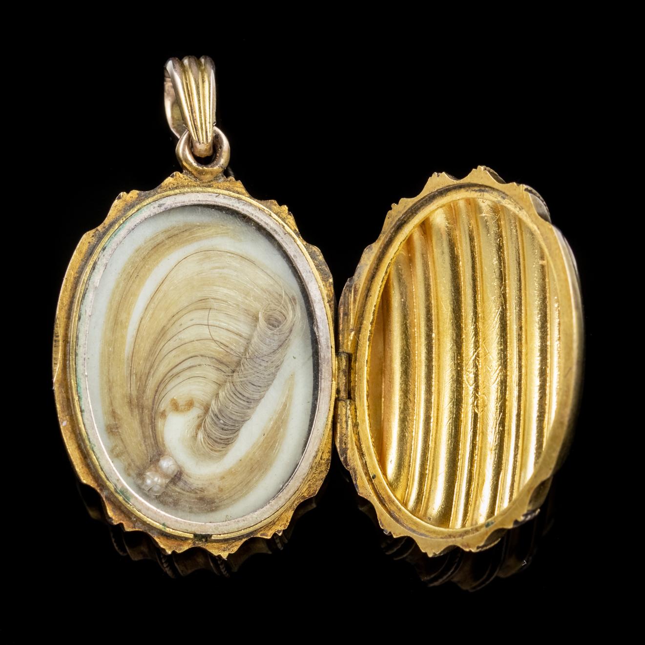 A splendid antique Victorian Mourning locket modelled in 15ct Yellow Gold with a wonderful ribbed surface on both sides. 

The piece opens up to reveal a fabulous display of curled hair showcased behind a glass window. It has been beautifully