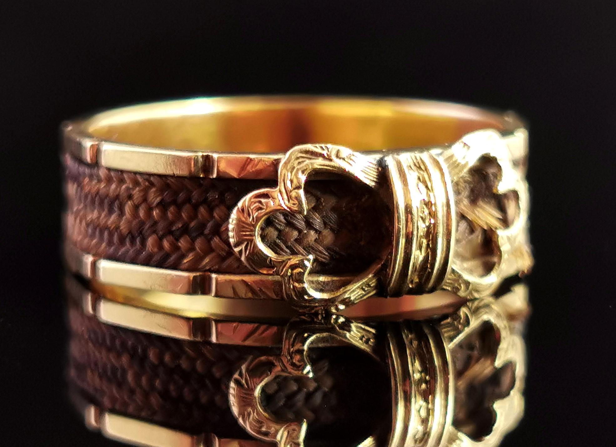 A stunning antique Victorian mourning ring.

Rich 15 karat yellow gold band with a shaped rim and a beautiful gold bow design front, the bow is lightly engraved.

The gold band is covered with light brown woven hair which stretches all the way