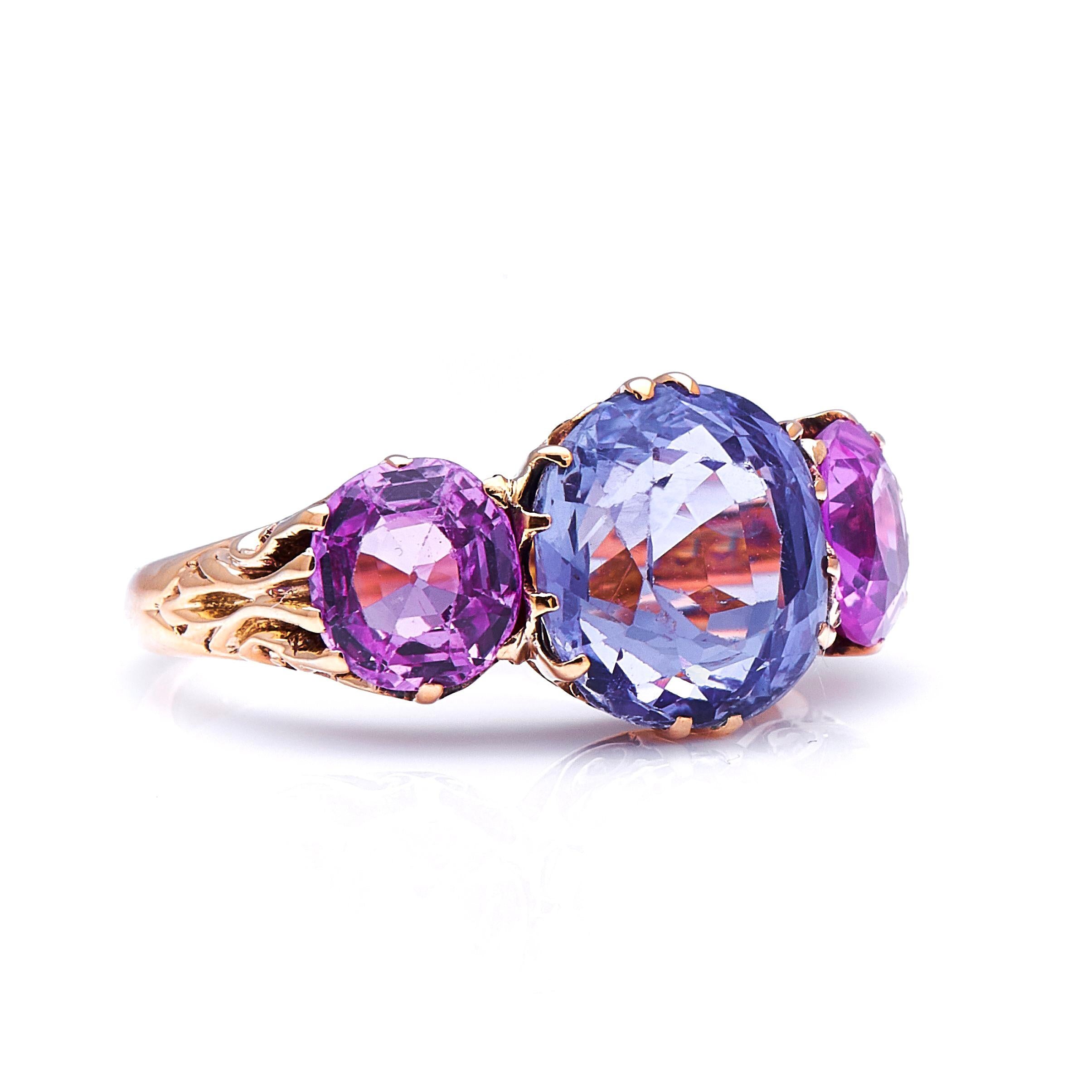 Pink and blue sapphire ring. Sapphires are celebrated for their enormous range of beautiful colours, shown off to great effect by this charming and unusual ring. The central sapphire, weighing approximately 5.1 carats, is a pale, silvery blue in