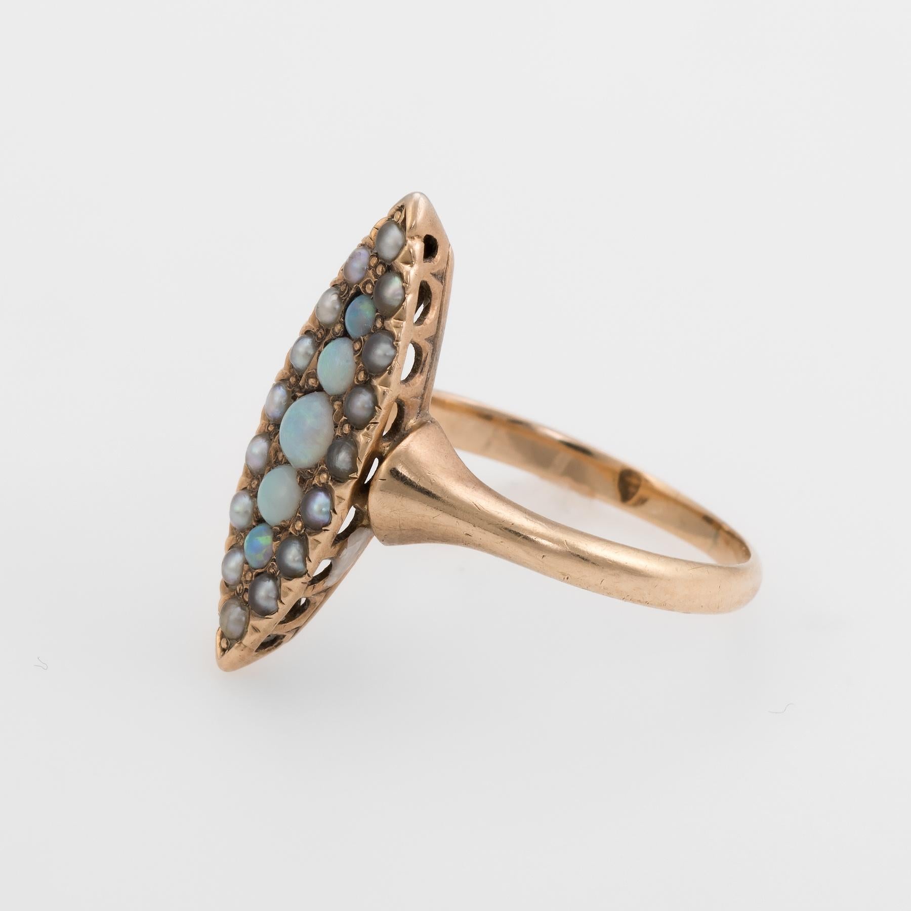 Victorian era navette ring (circa 1880s to 1900s), crafted in 14 karat yellow gold.

Opals graduate in size from 1.5mm to 2.5mm. The seed pearls measure (average) 1.5mm. The opals are in excellent condition and free of cracks or chips.  

The ring