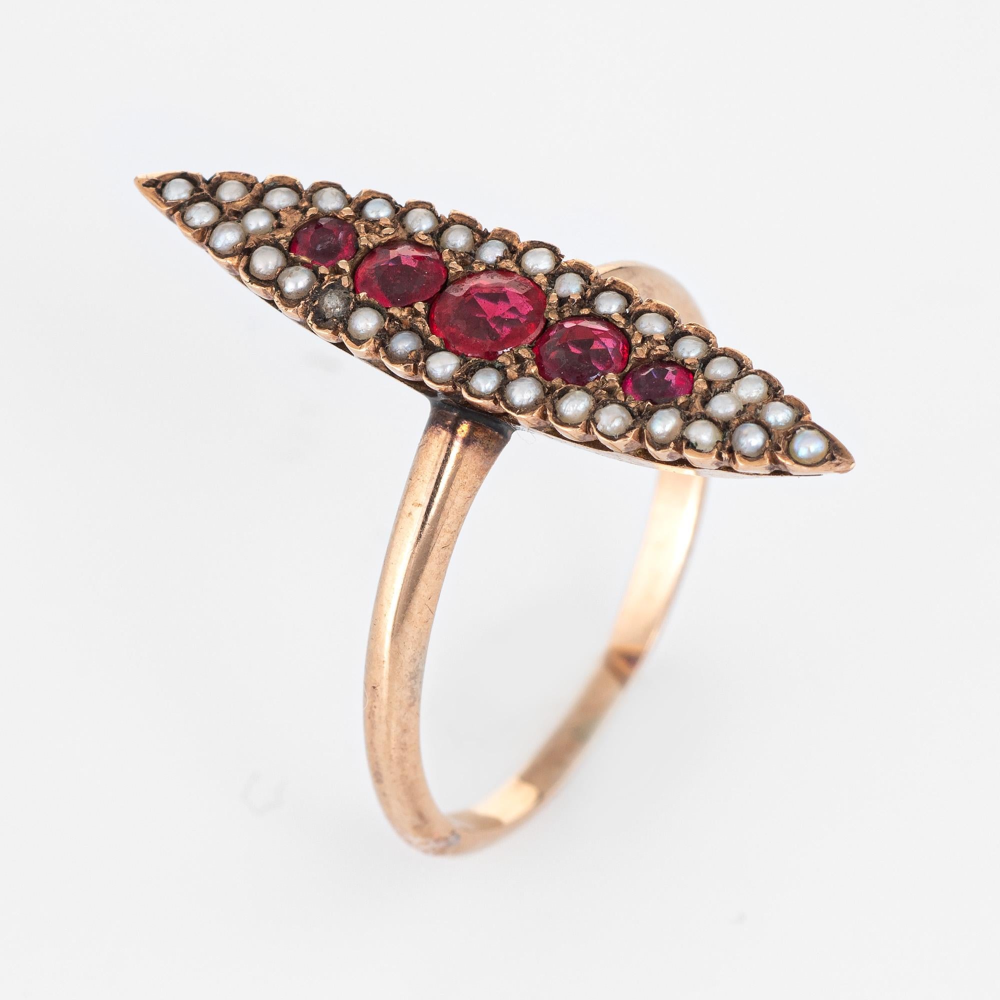 Finely detailed antique Victorian era ring (circa 1880s to 1900s) crafted in 14k yellow gold. 

Ruby doublets range in size from 0.03 to 0.10 carats. The seed pearls measure (average) 1mm. Note: light surface abrasions to the rubies.  

A center set