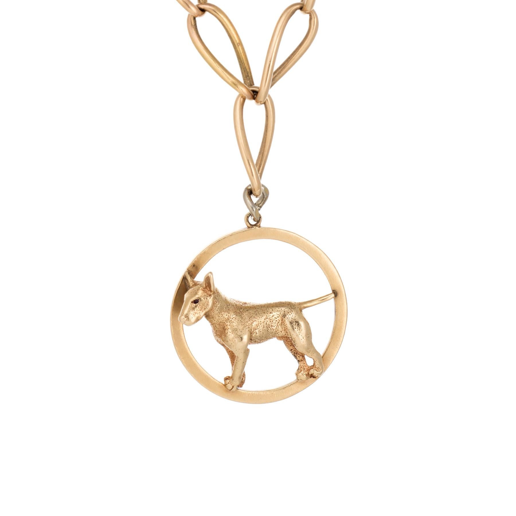 Elegant and finely detailed antique Victorian necklace, crafted in 14 karat yellow gold. Attached to the necklace is a 14 karat yellow gold dog medallion pendant by Ruser (circa 1950s). 

Two estimated 0.01 carat rubies are set into the dogs eyes