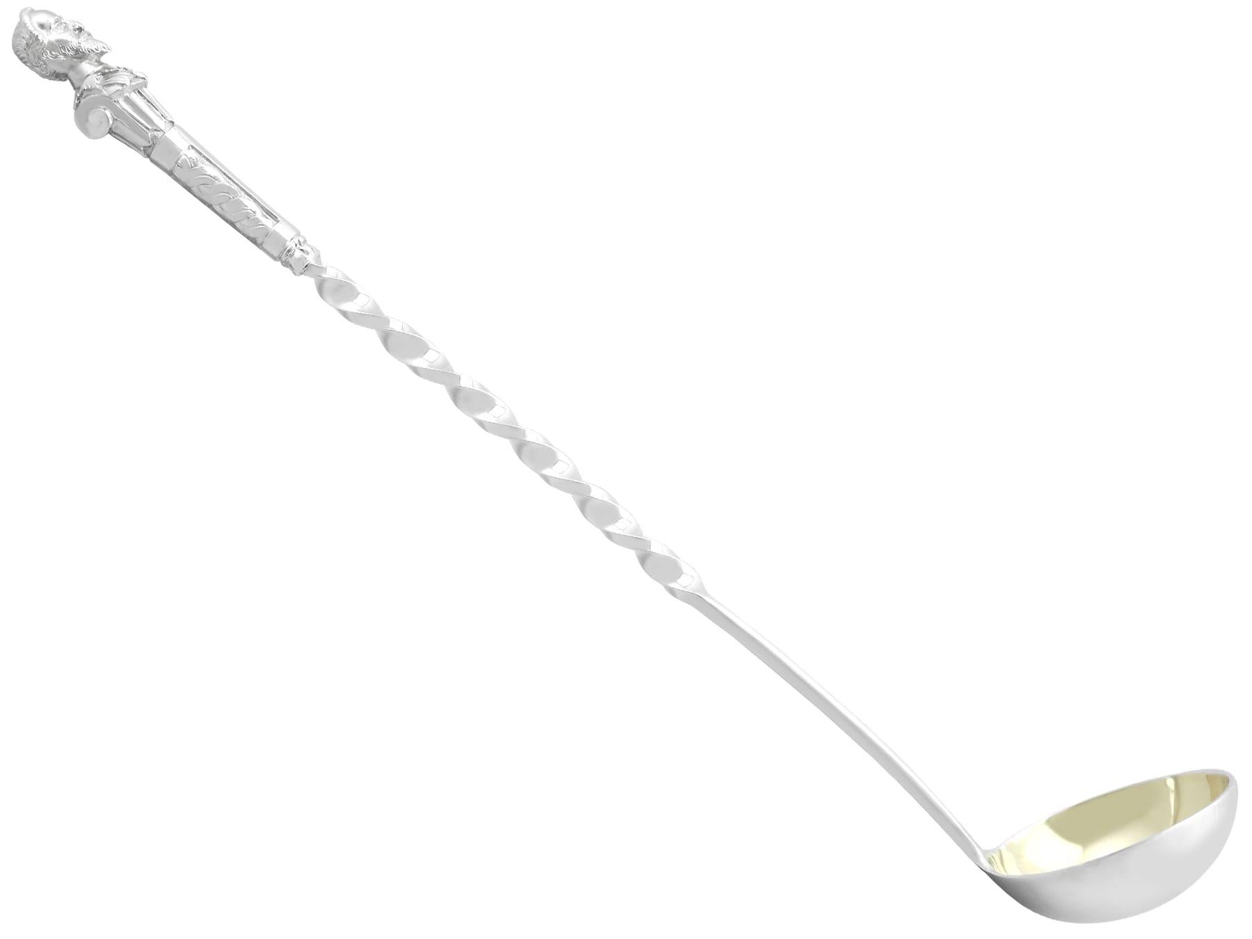 An exceptional, fine and impressive, rare antique Victorian English sterling silver punch ladle; an addition to our silver flatware collection.

This exceptional and rare antique Victorian cast sterling silver punch ladle has a plain circular