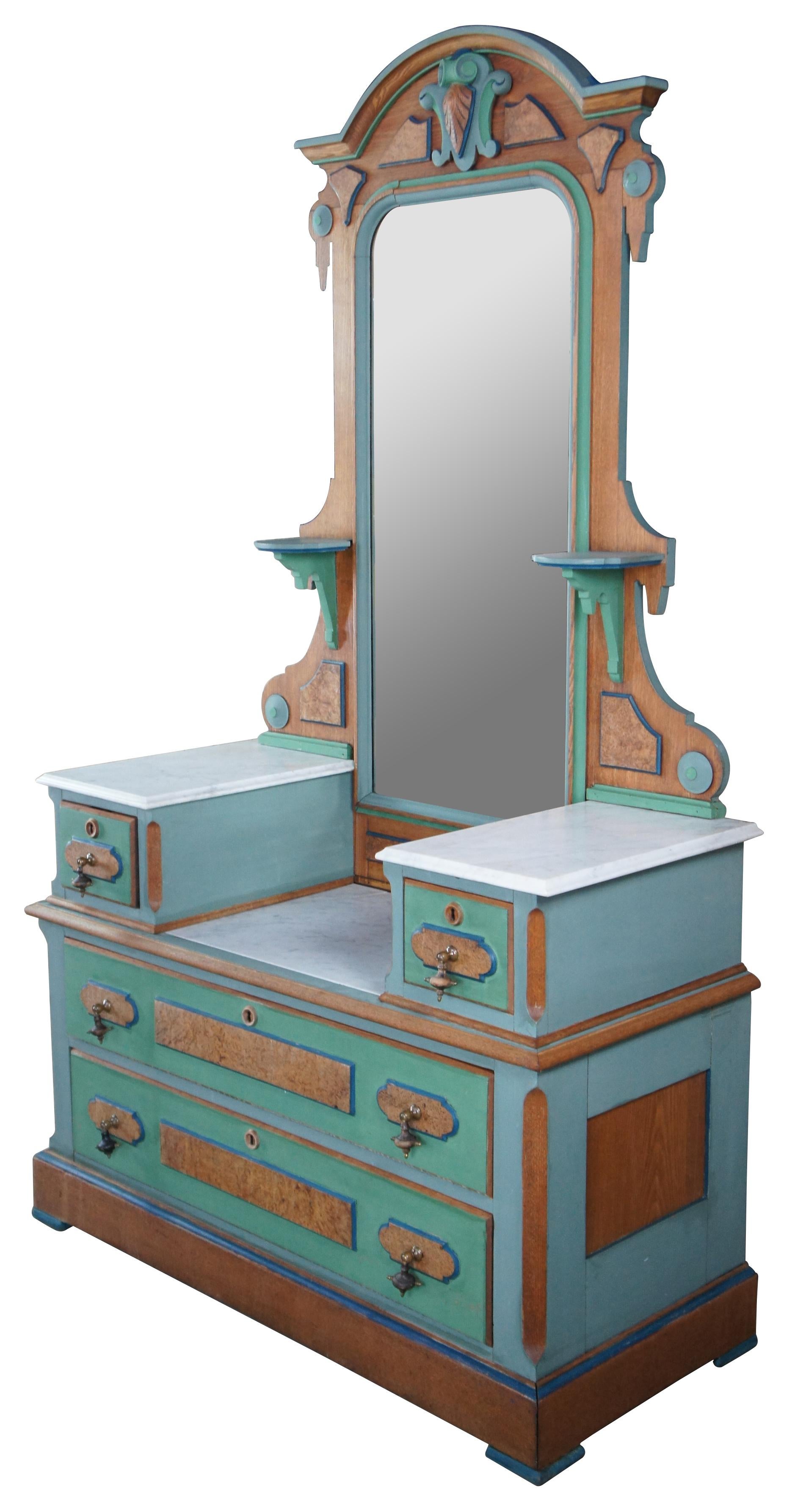 Antique Victorian Eastlake gentlemans dropwell mirrored vanity dresser or shaving / wash stand. Made of oak featuring birdseye maple panels with painted accents, marble tops, and multiple drawers with brutalist tear drop pulls.

Measures: 46.5