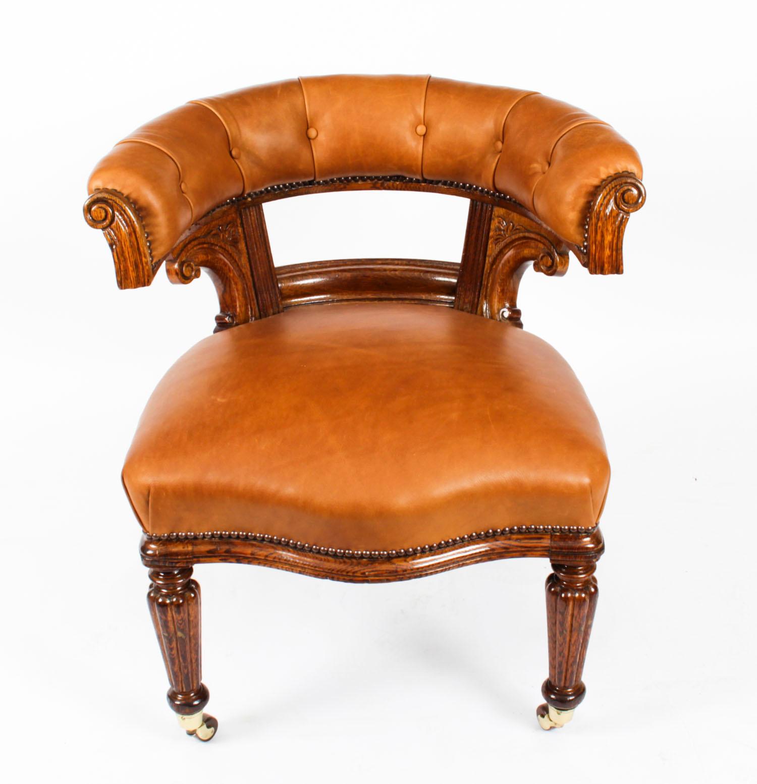 This is a very comfortable, antique Victorian oak desk chair c.1880 in date.

It is made of oak, has beautiful hand carved decoration and sumptuous tan leather upholstery.

The chair is raised on turned tapered and reeded front legs.

It will