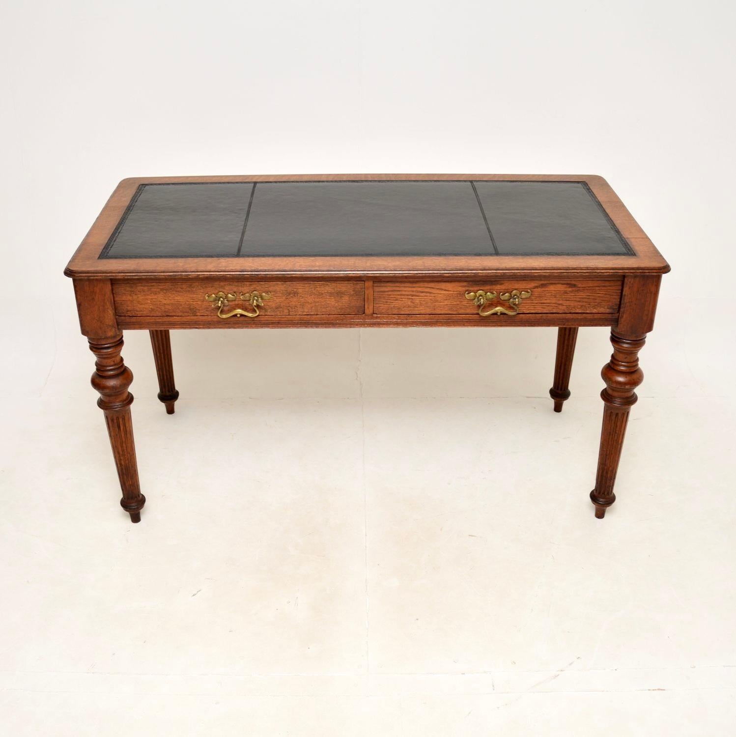 An impressive antique Victorian oak leather top writing table / desk. This was made in England, it dates from around the 1870-1890 period.

It is of superb quality, solid oak throughout with a lovely inset faded black leather writing surface. It