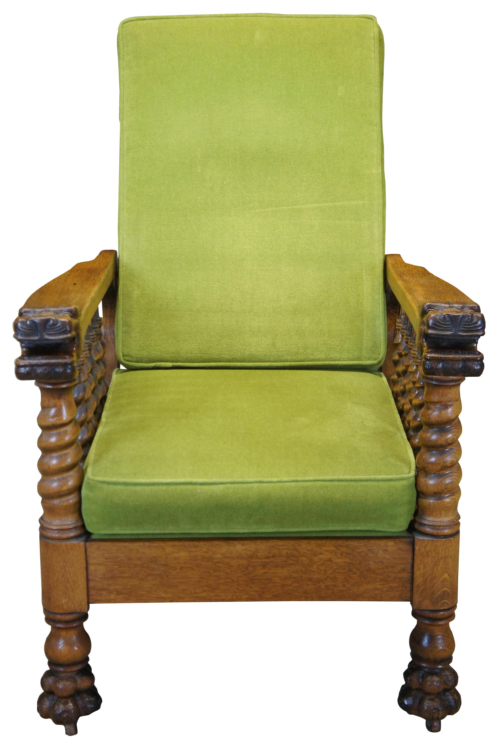 Late 19th century Victorian armchair. The Morris chair was known for its unique staged reclining mechanism. This beautiful example is made from oak with turned barley twist supports and figural lion head arms. Features lion paw feet with castors and