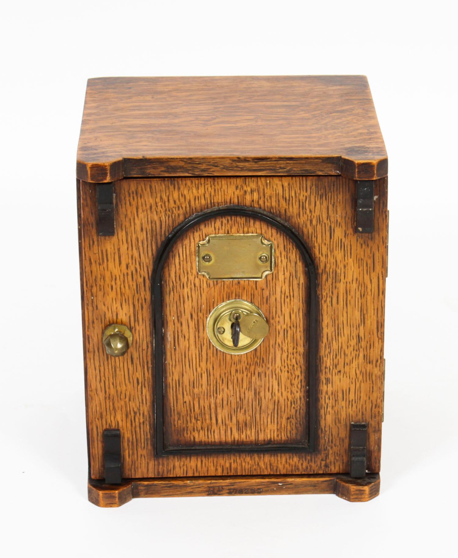 This is a stylish antique Victorian oak novelty table top cigar box, circa 1870 un date.

The rectangular box is in a form of a safe, it features a panelled door with brass handle and central lock, opening to reveal two drawers with gothic revival