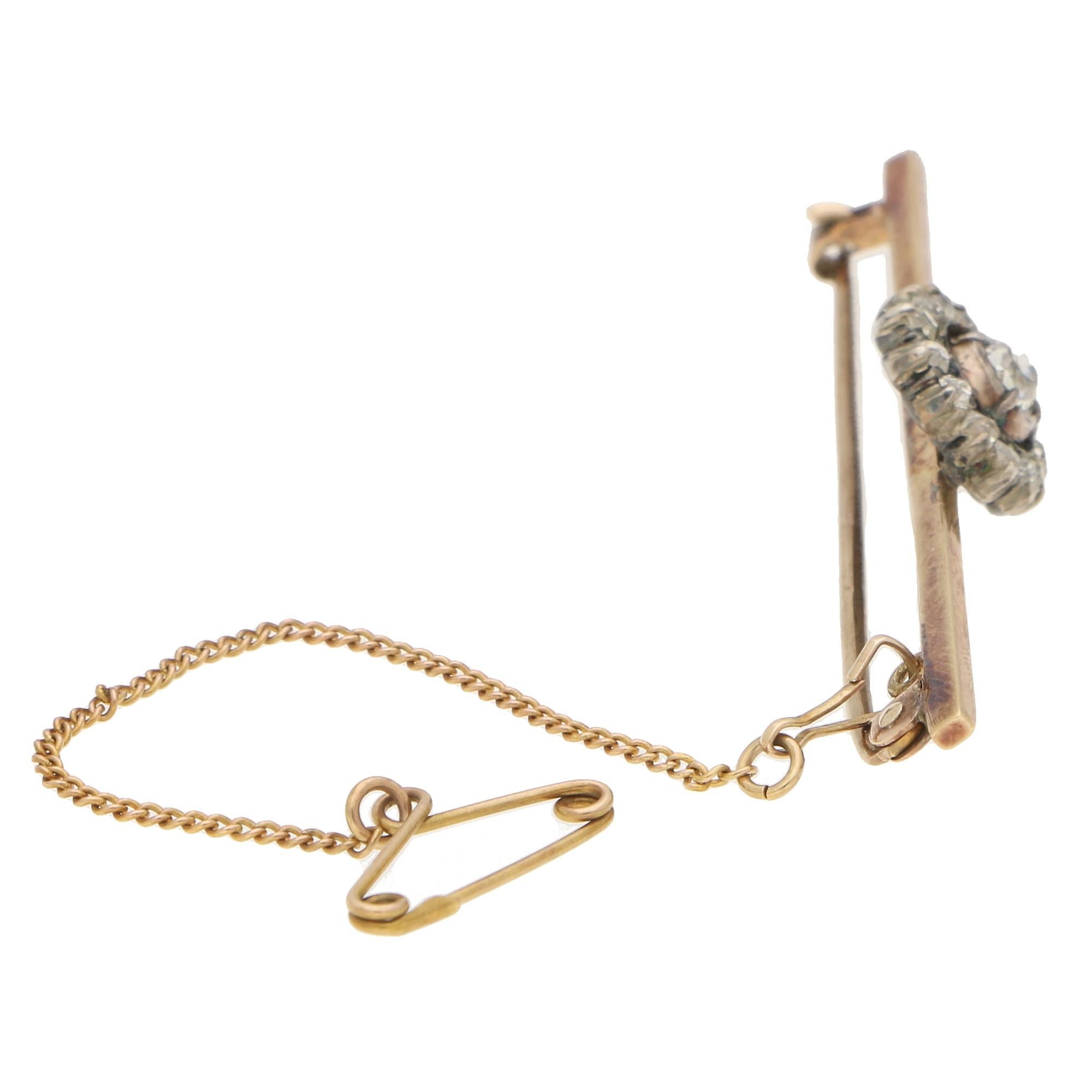A beautiful Victorian old mine cut diamond bar pin brooch set in silver on gold. 

This lovely piece is predominantly set with an elegant Victorian cluster set throughout with old mine cut diamonds in the traditional 'cut away' setting. The brooch