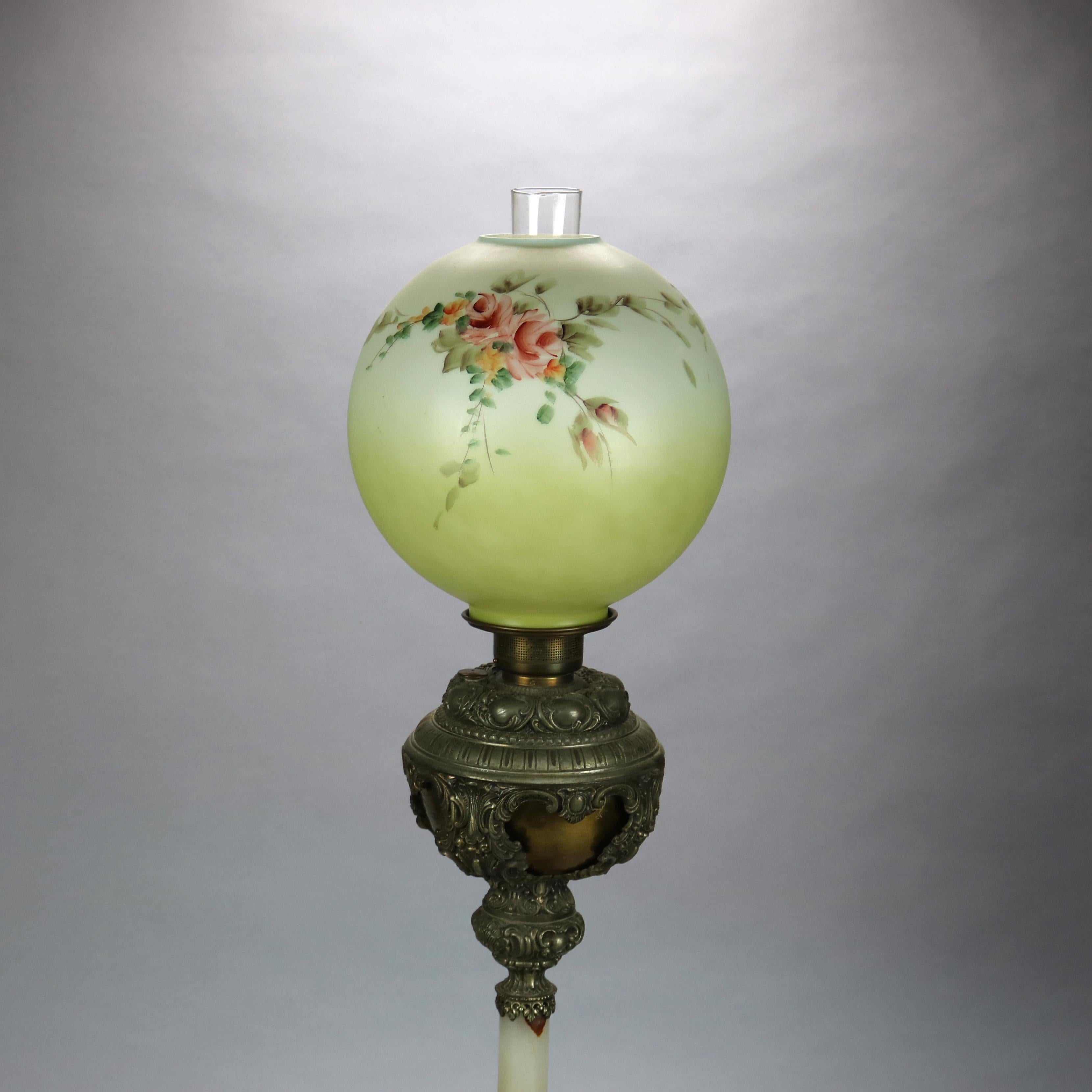 An antique Victorian parlor table lamp offers hand painted floral globe overs base with gilt metal and pierced font and base with onyx column, electrified, c1890

Measures: 35