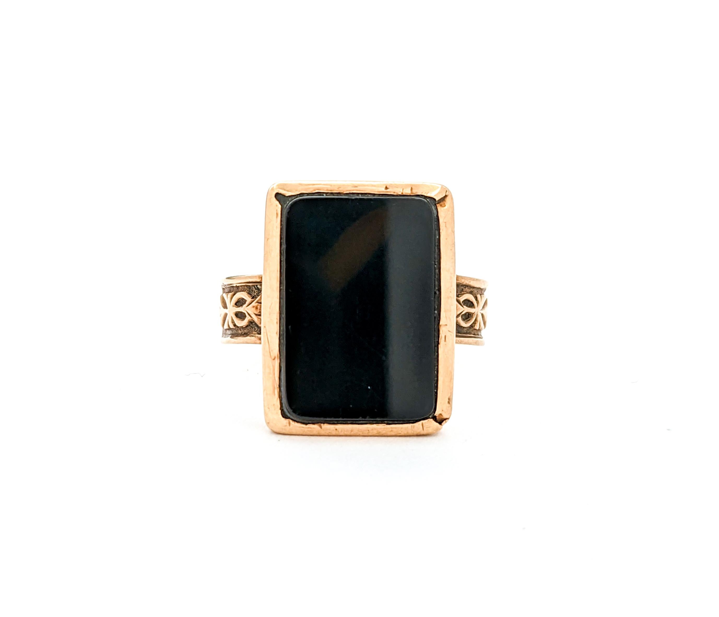 Antique Victorian Onyx Ring In Yellow Gold

Step back in time with this exquisite Antique Ring from the Victorian era, meticulously crafted in 10k yellow gold. This piece features a glossy 15x11mm rectangular Onyx as its centerpiece. The Onyx, known