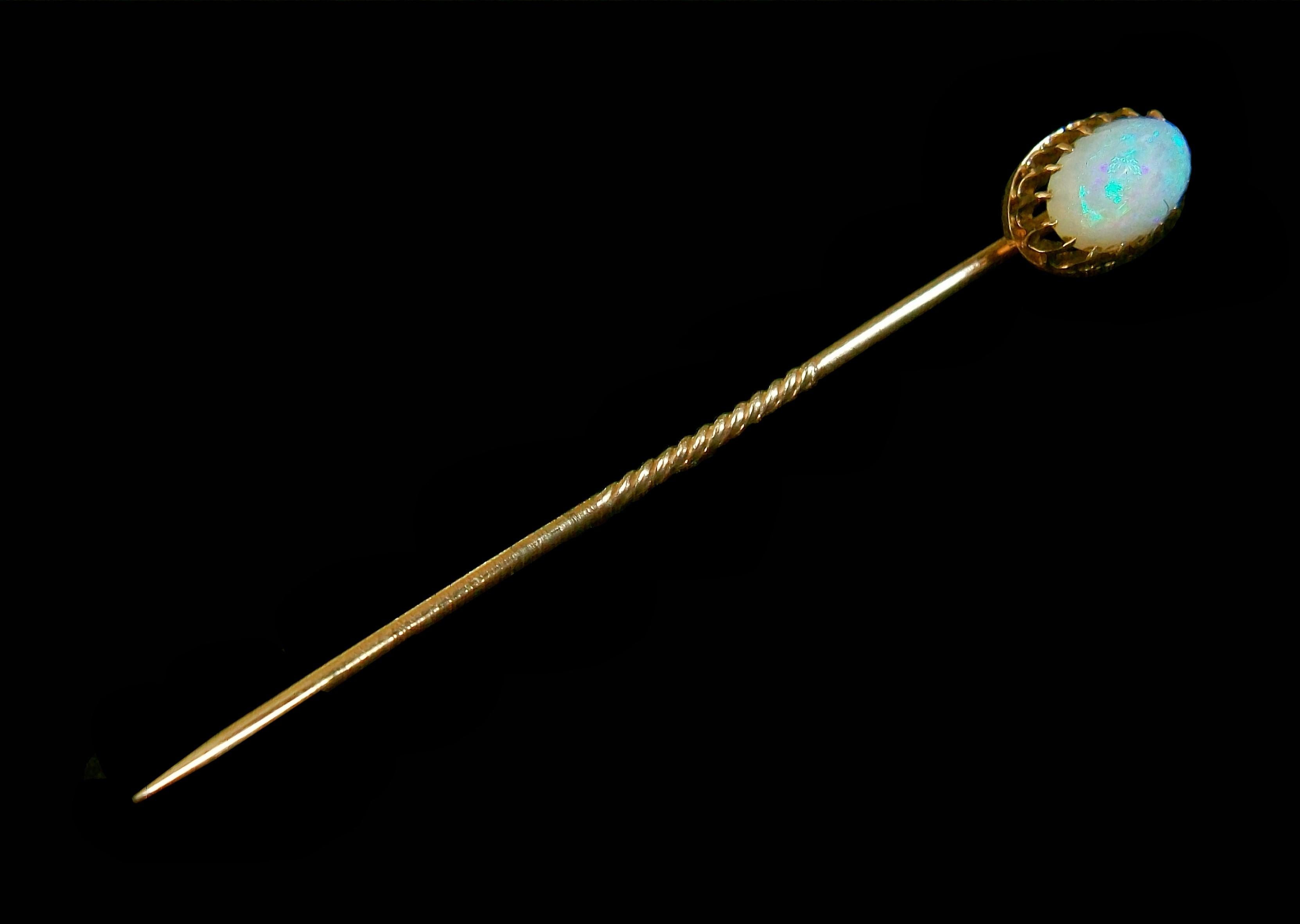 Antique late Victorian 18K yellow gold stick pin - featuring a prong set oval cabochon opal (approximately 8 mm. Long x 6 mm. Wide x 4 mm. Deep = 1.04 carat weight) - twisted central section to the pin - completely hand made - warm aged patina -