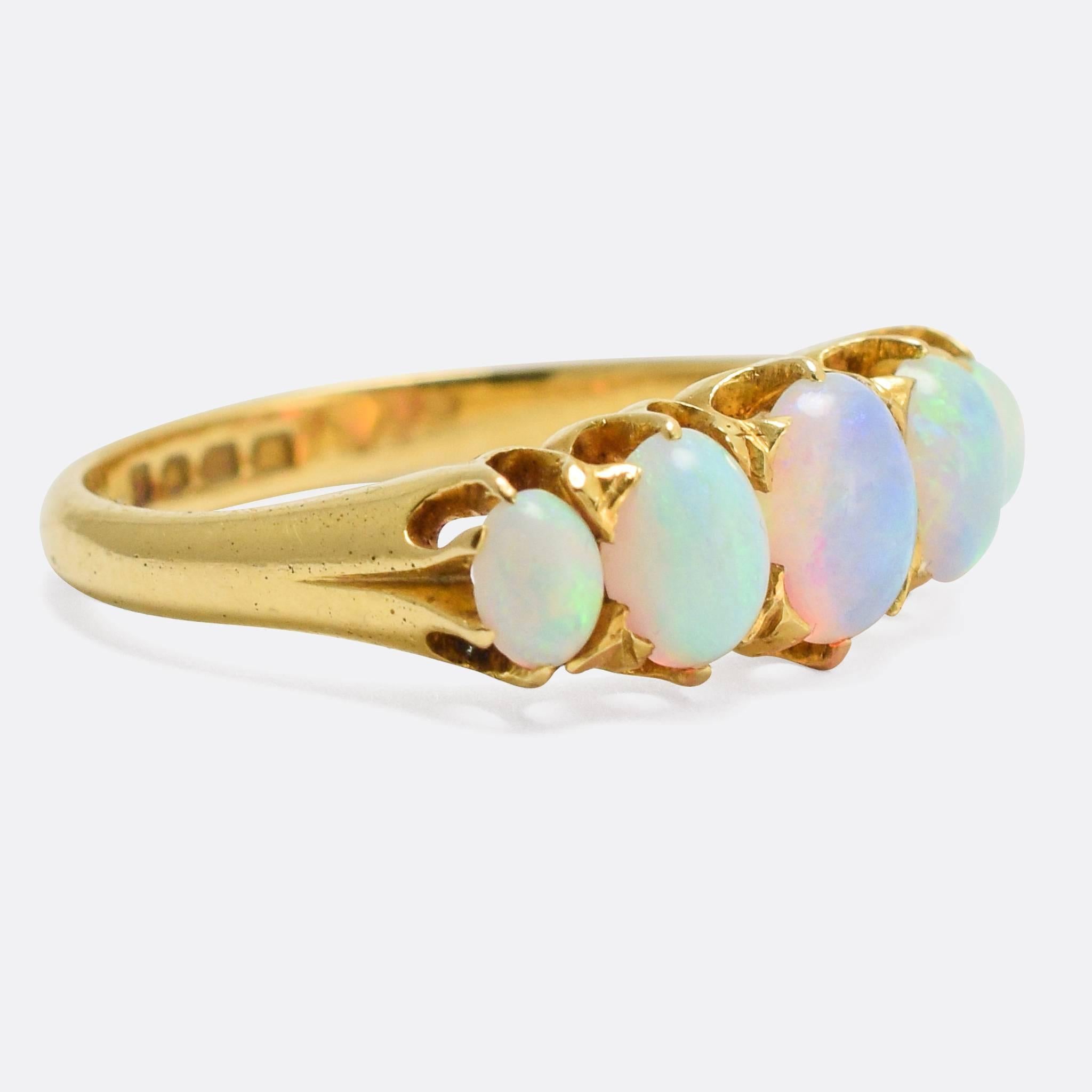 A classic Late Victorian 5-Stone Opal Ring, set with particularly vibrant oval cabochon stones. The scalloped claw settings are very typical of the era - it was made in the year 1900 - and the piece is modelled in 18 karat gold, with clear hallmarks