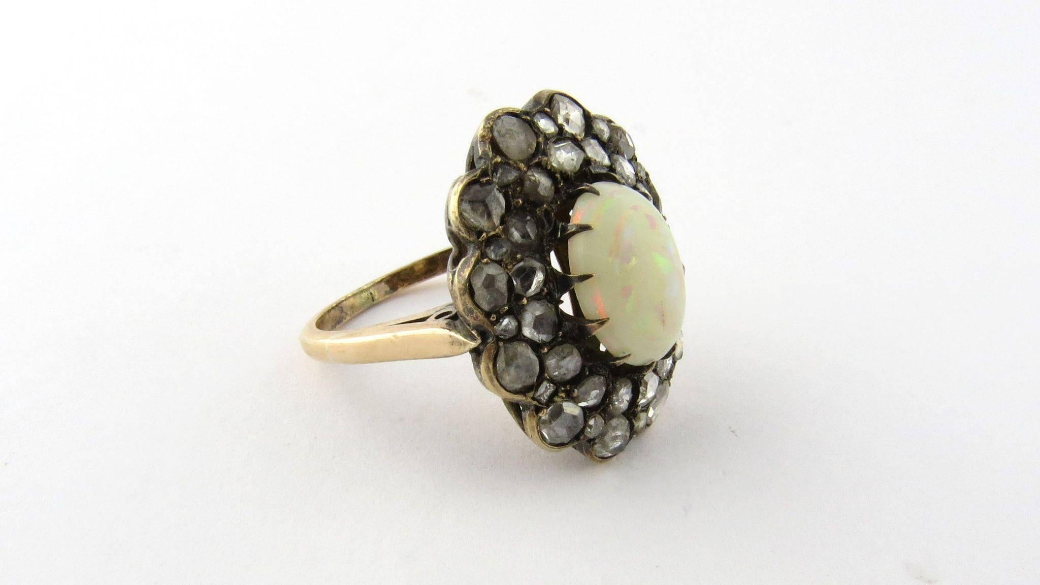 Antique Victorian Opal and Rose Cut Diamond 

14k Yellow Gold Ring 

Size 5 

This cluster ring is set with a center genuine opal that is surrounded by rose cut diamonds. 

The opal is approximately 11 mm x 8.5 mm 

40 rose cut diamonds ranging in