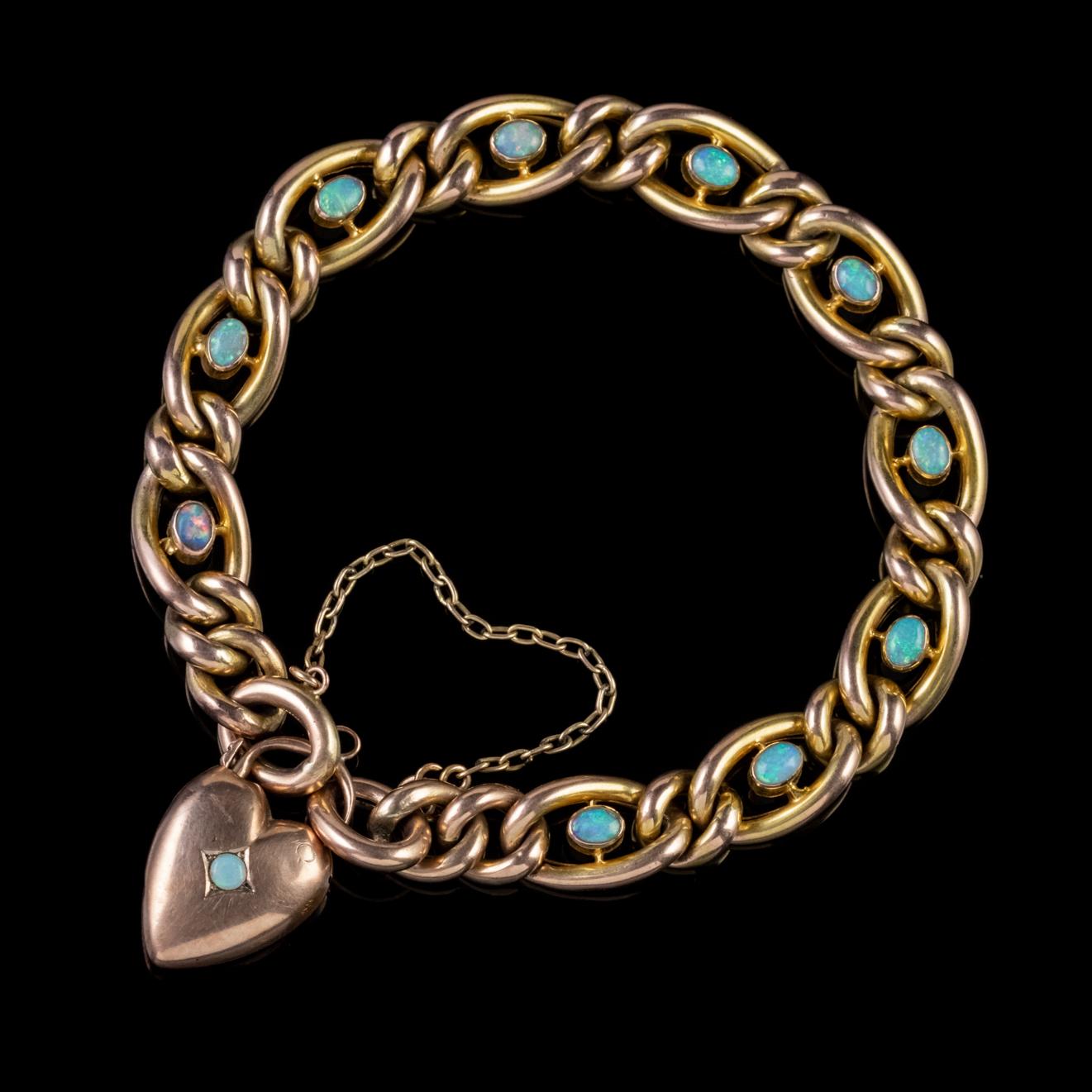 A beautiful Antique late-Victorian curb bracelet made by the Atkinson Brothers, Circa 1900. The lovely piece is fashioned in 9ct Yellow Gold and decorated with ten colourful natural Opals, approx. 0.15ct each. 

Opal is a kaleidoscope of rainbow