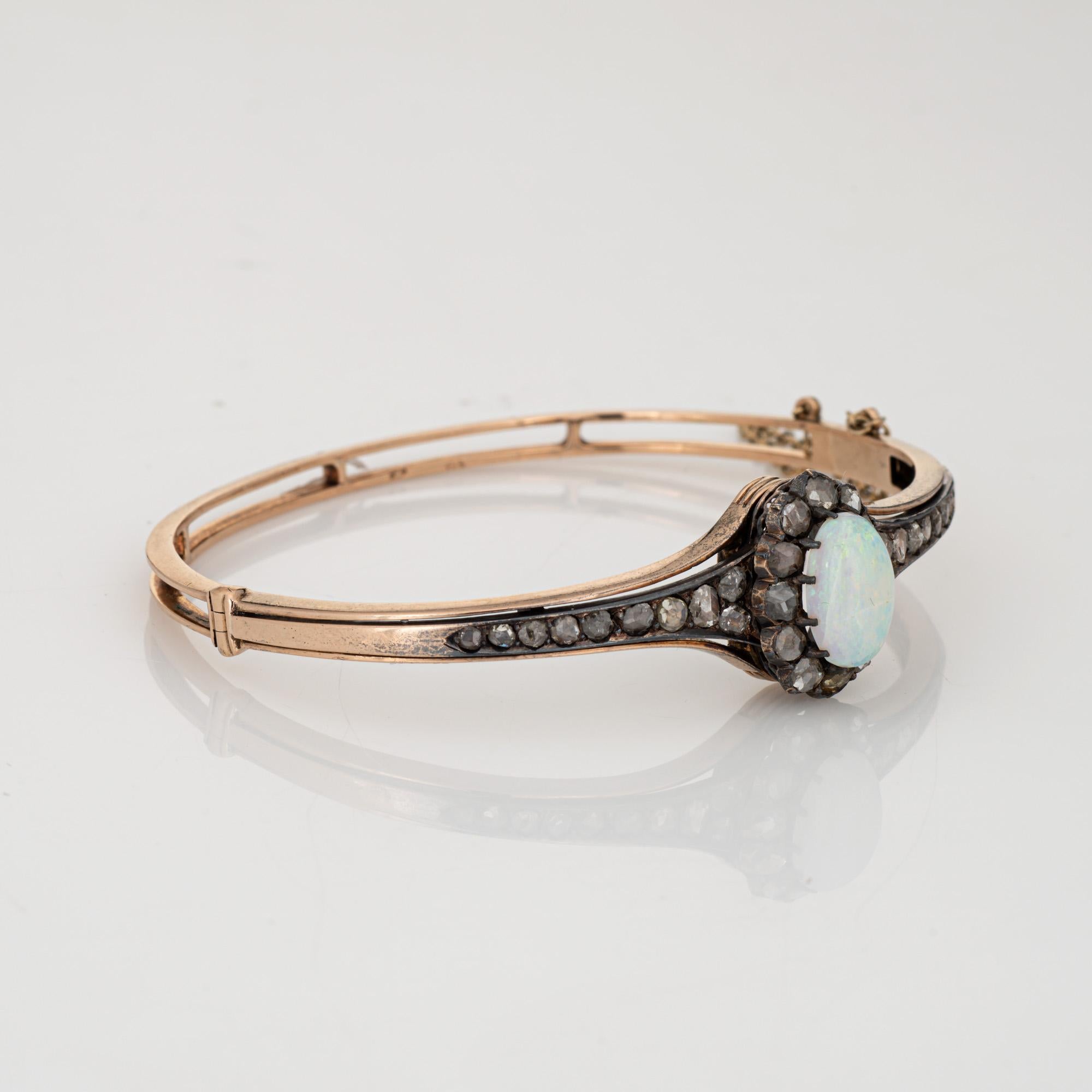 Finely detailed antique Victorian opal & diamond bangle bracelet (circa 1880s to 1900s), crafted in 14k yellow gold and silver. 

Cabochon cut opal measures 11.5mm x 7mm. 32 old rose cut diamonds measure (average) approx. 2mm.
The medium dome