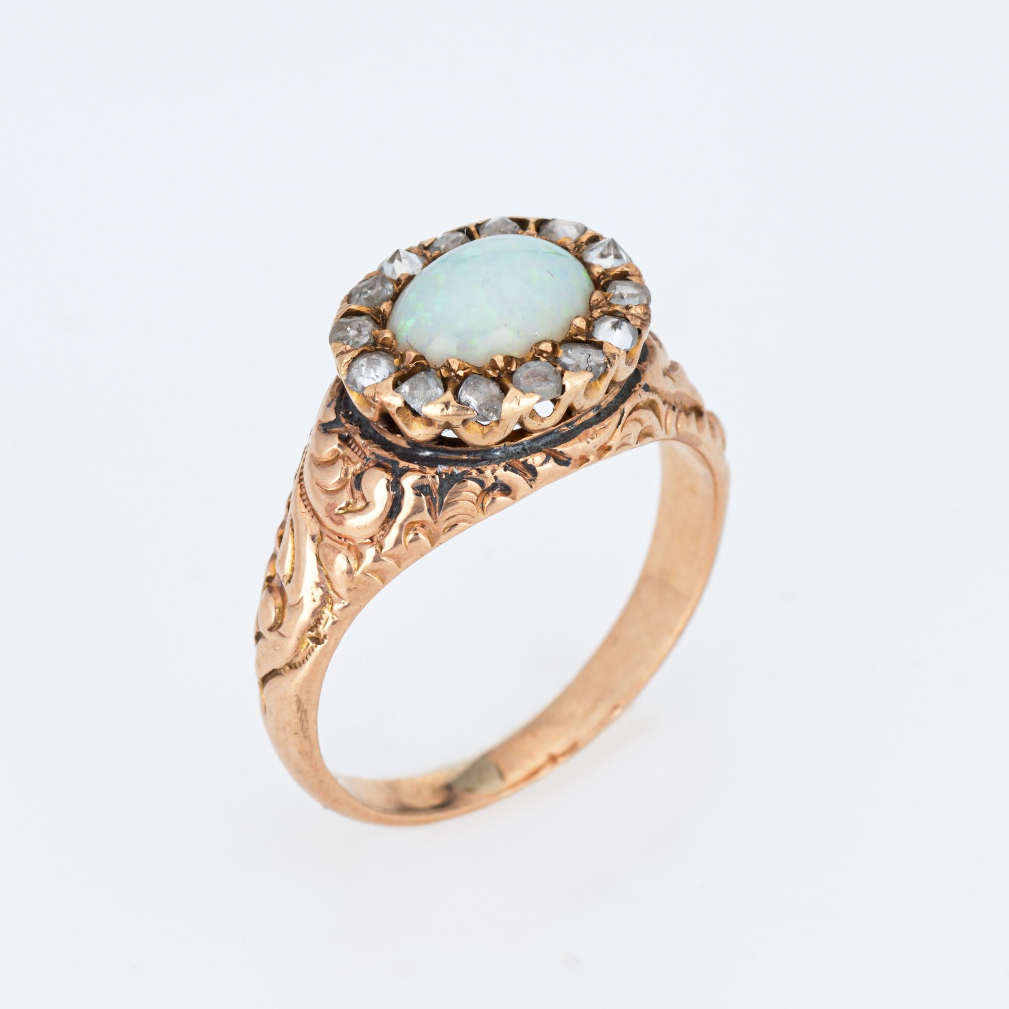 Stylish antique Victorian era ring (circa 1880s to 1900s), crafted in 14 karat yellow gold.

One opal measures 7mm x 5mm, accented with 14 estimated 0.02 carat old rose cut diamonds. The total diamond weight is estimated at 0.28 carats (estimated at