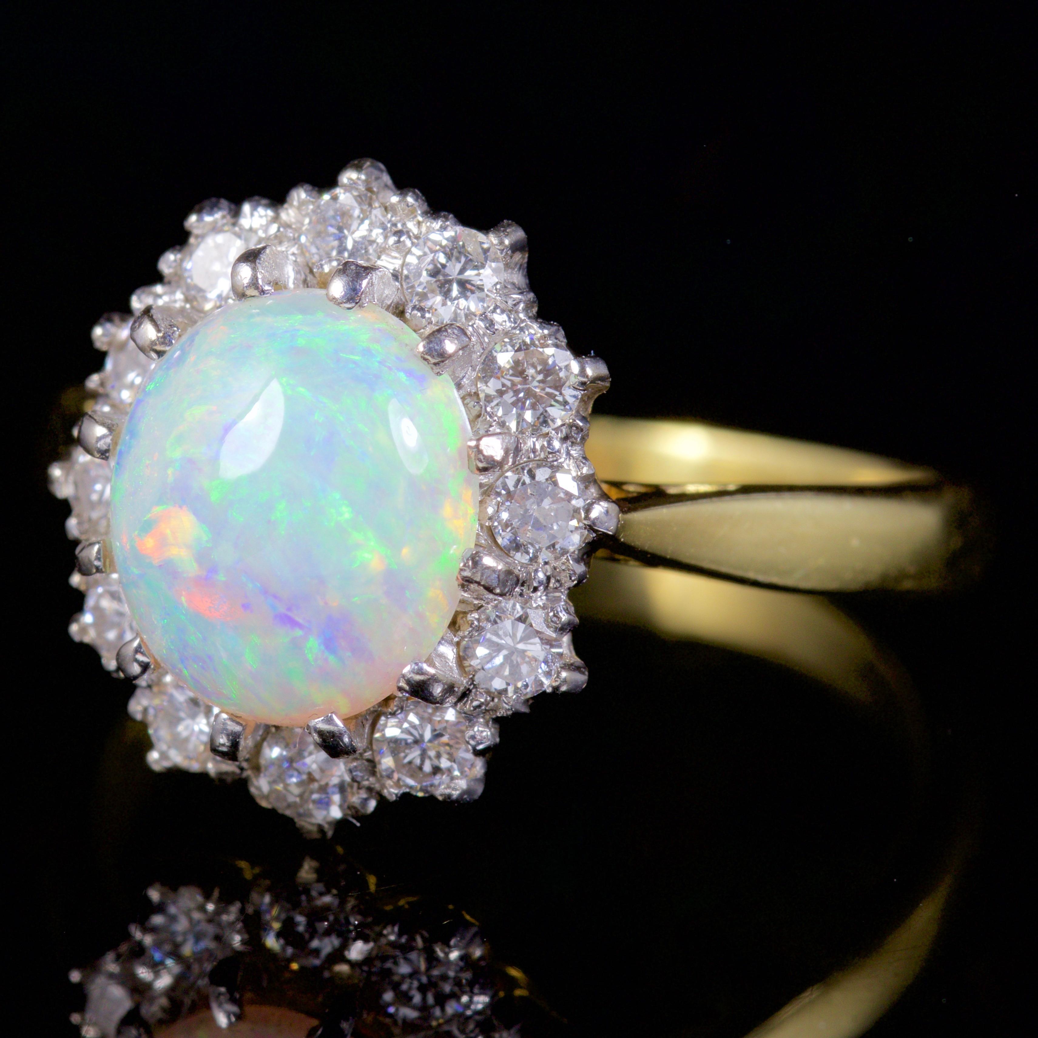 This very beautiful Victorian Opal and Diamond ring is Circa 1900.

The ring is decorated in the most wonderful 2ct natural Opal, with a halo of glistening Diamonds surrounding it.

Each Diamond is 0.07ct, and there are 12 Diamonds, which totals to