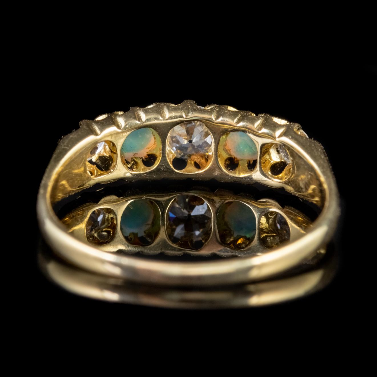 A beautiful antique Victorian ring adorned with a trio of old European cut Diamonds with two natural 0.10ct Opals in-between.

Opal is a kaleidoscope of rainbow colours shimmering and changing colours with the light. It radiates blues, pinks, greens