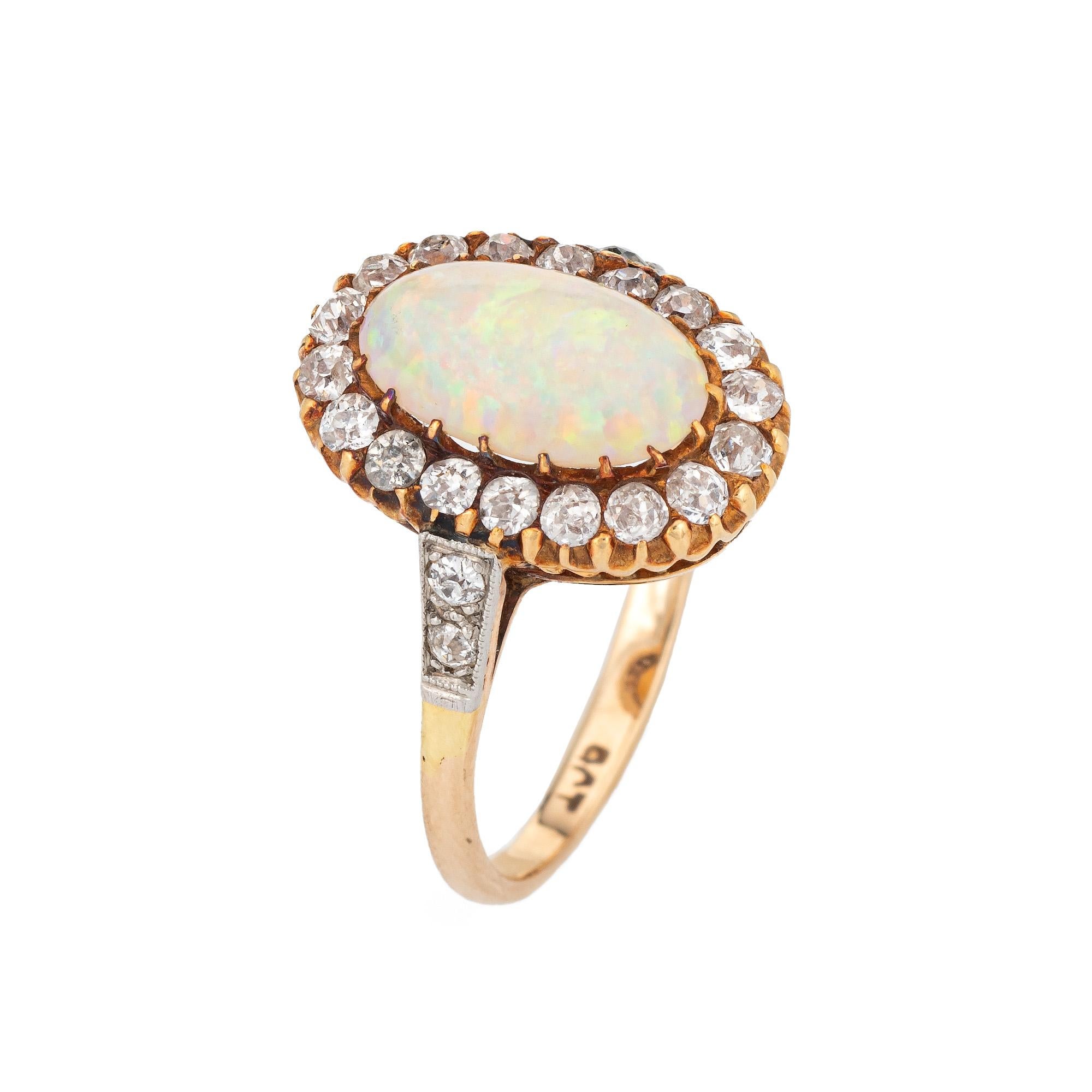 Elegant antique Victorian opal & diamond ring (circa 1880s to 1900s) crafted in 9 karat yellow gold. 

Natural opal measures 11mm x 7mm (estimated at 1.50 carats). 22 old mine cut diamonds total an estimated 1 carat (estimated at J-K color and