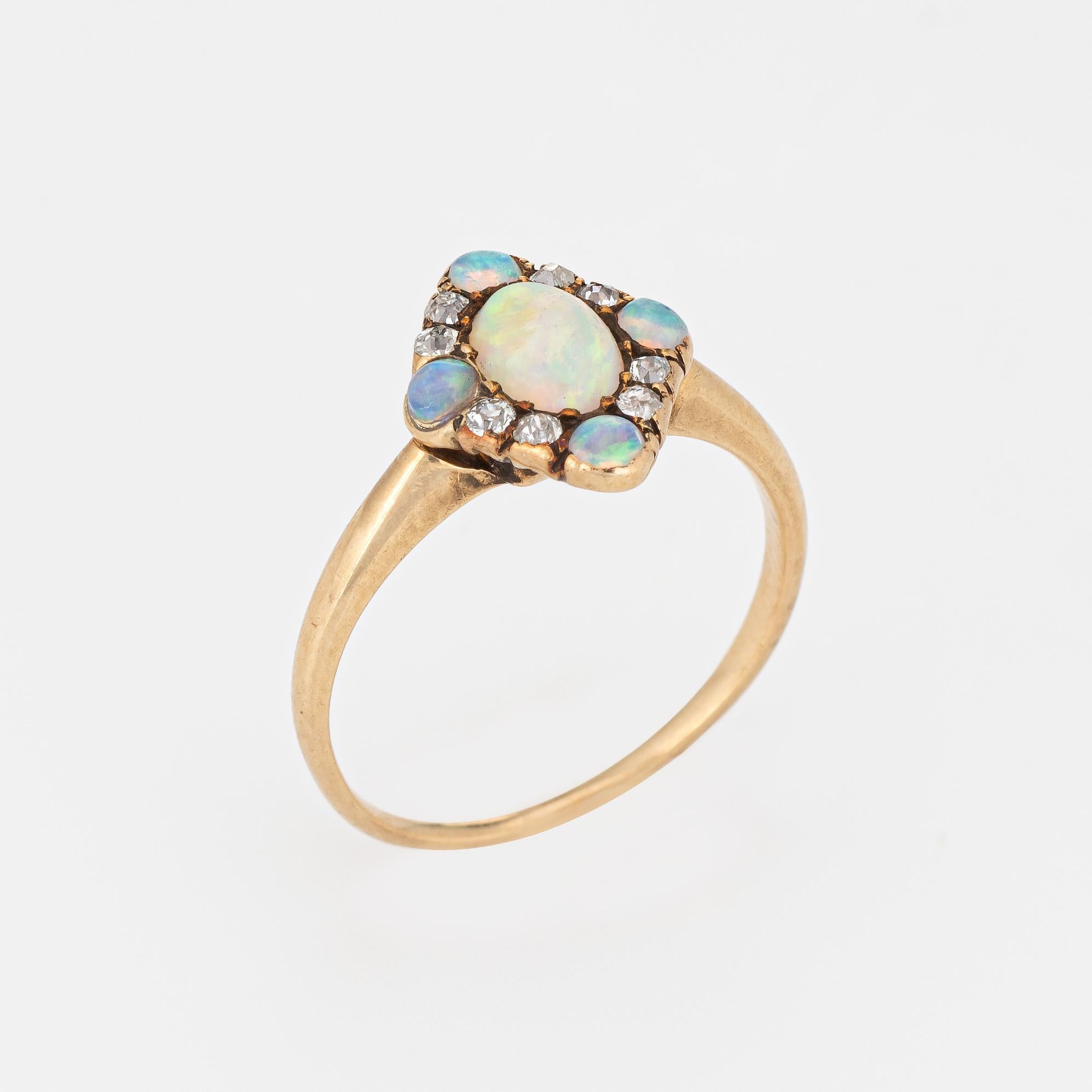 Finely detailed antique Victorian opal & diamond ring (circa 1880s to 1900s), crafted in 14 karat rose gold. 

Center set opal measures 5.5mm x 4mm (estimated at 0.30 carats), accented with a further four 2.25mm opals. Eight old mine cut diamonds