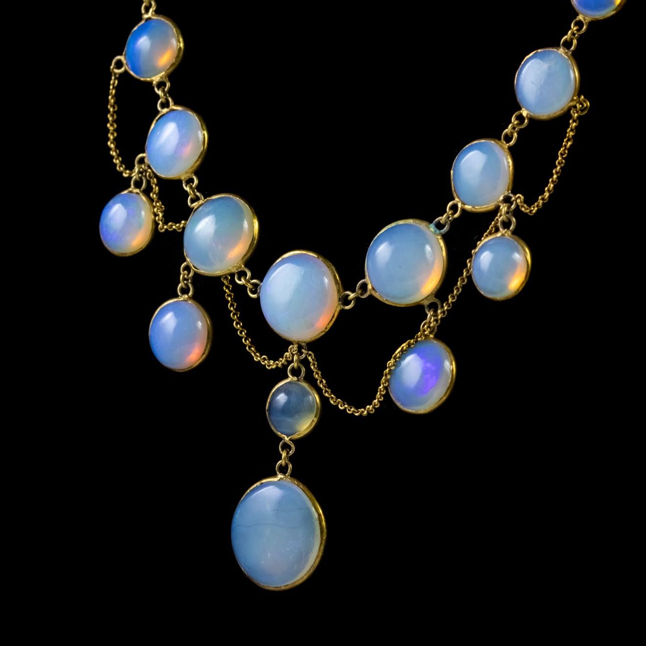 This wonderful Victorian festoon necklace has been lovingly crafted in 18ct Yellow Gold and adorned with fifteen beautiful cabochon cut natural Opals. The largest opal is 4ct alone, in total the stones add up to over 20ct.

The fine links that