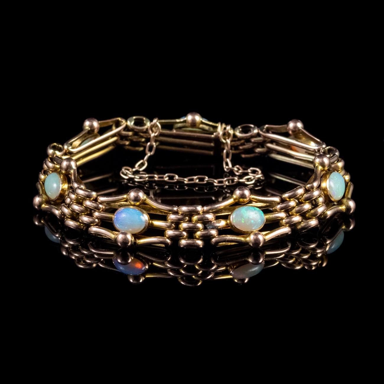 This beautiful Antique Victorian gate link bracelet has been modelled in 9ct Yellow Gold which has developed a lovely rose hue with age and is set with seven 0.80ct Opals which total 5.60ct. It features a box clasp and safety chain to keep it